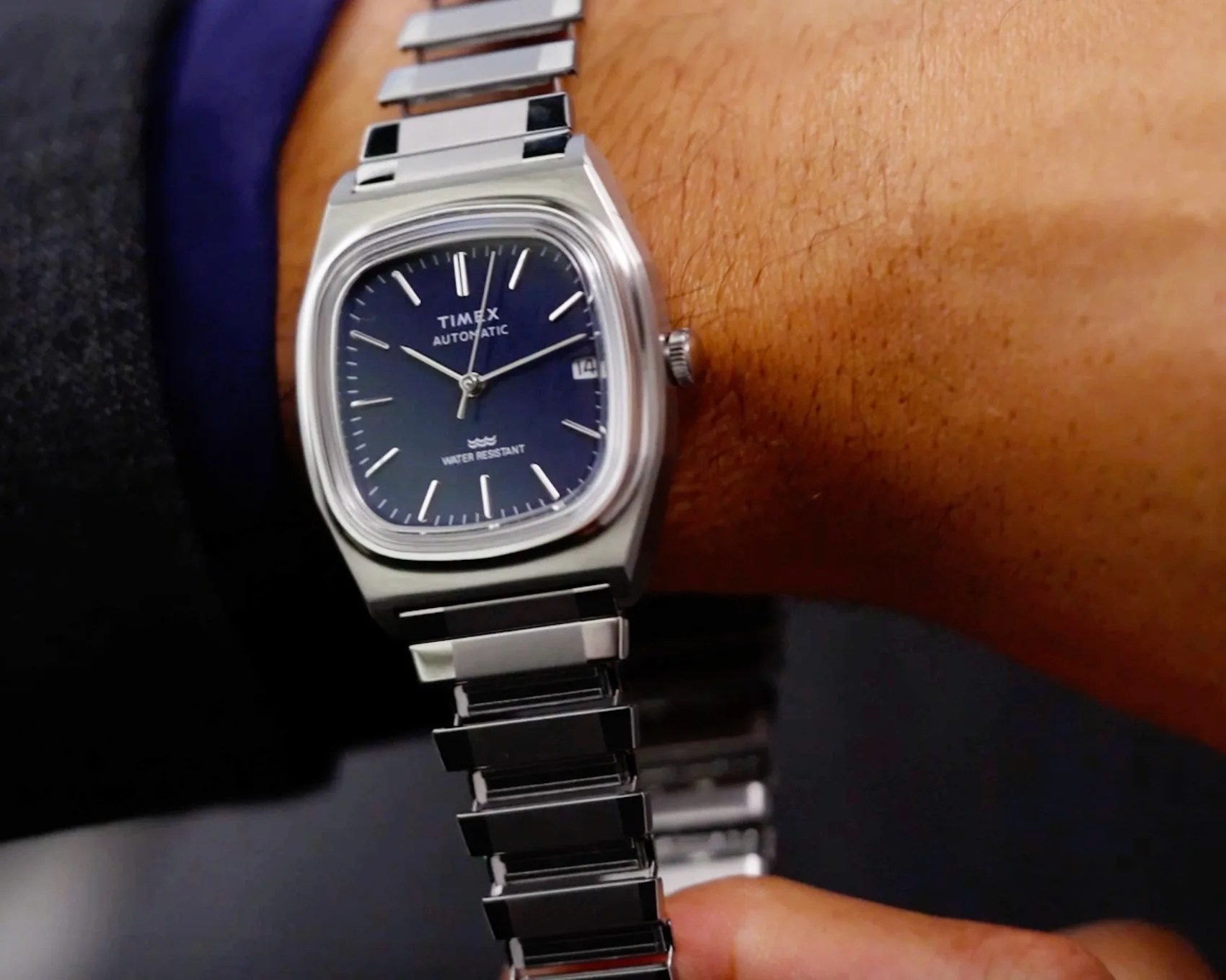the stretched out band on a silver Timex watch