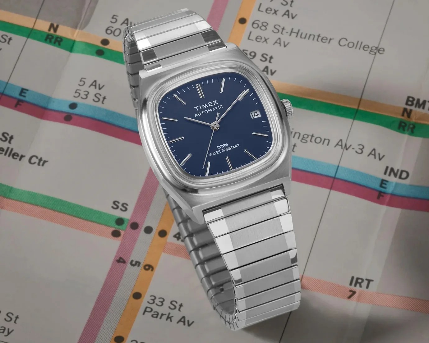 a silver timex watch with a blue dial
