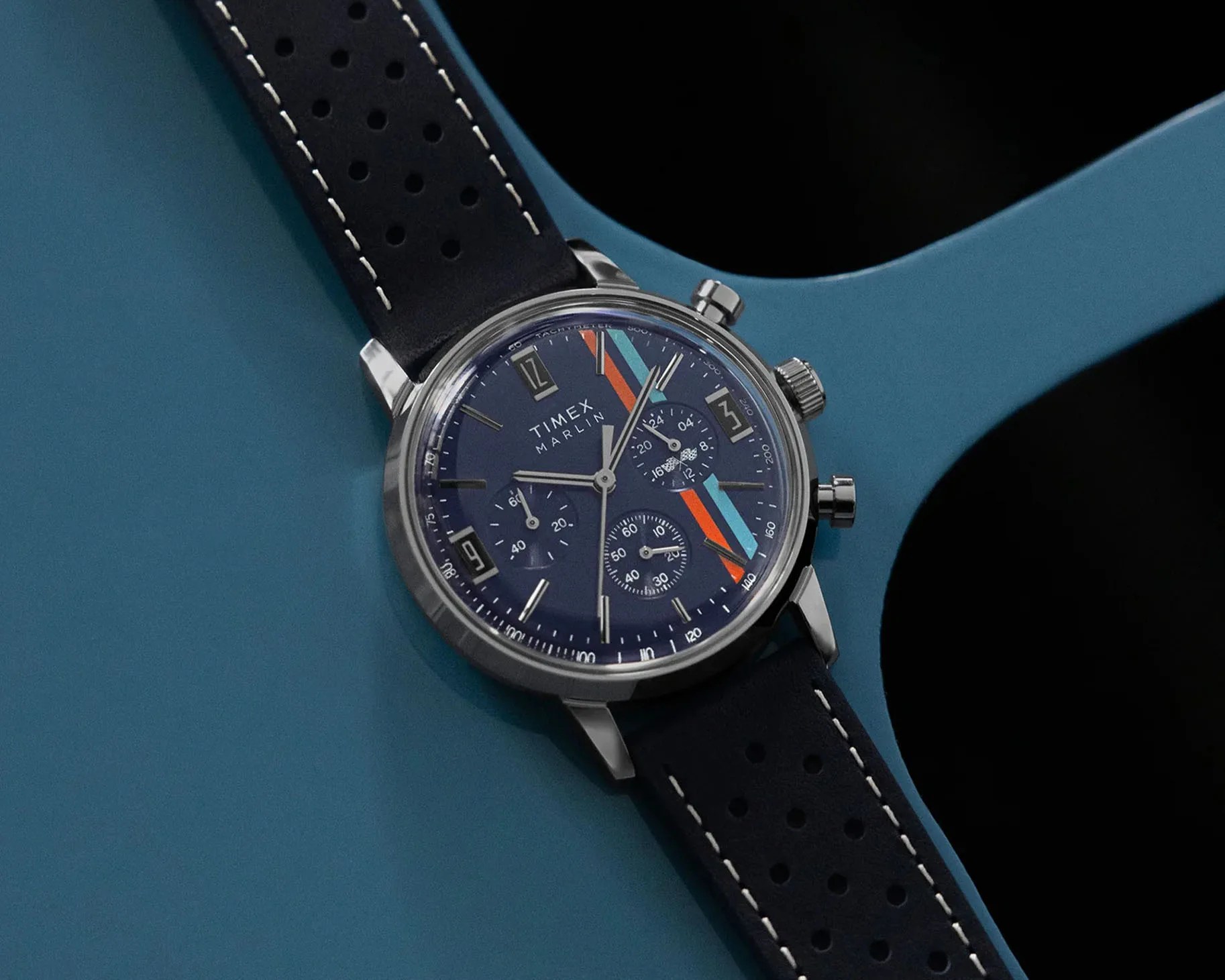 a blue chronograph watch on a blue leather strap