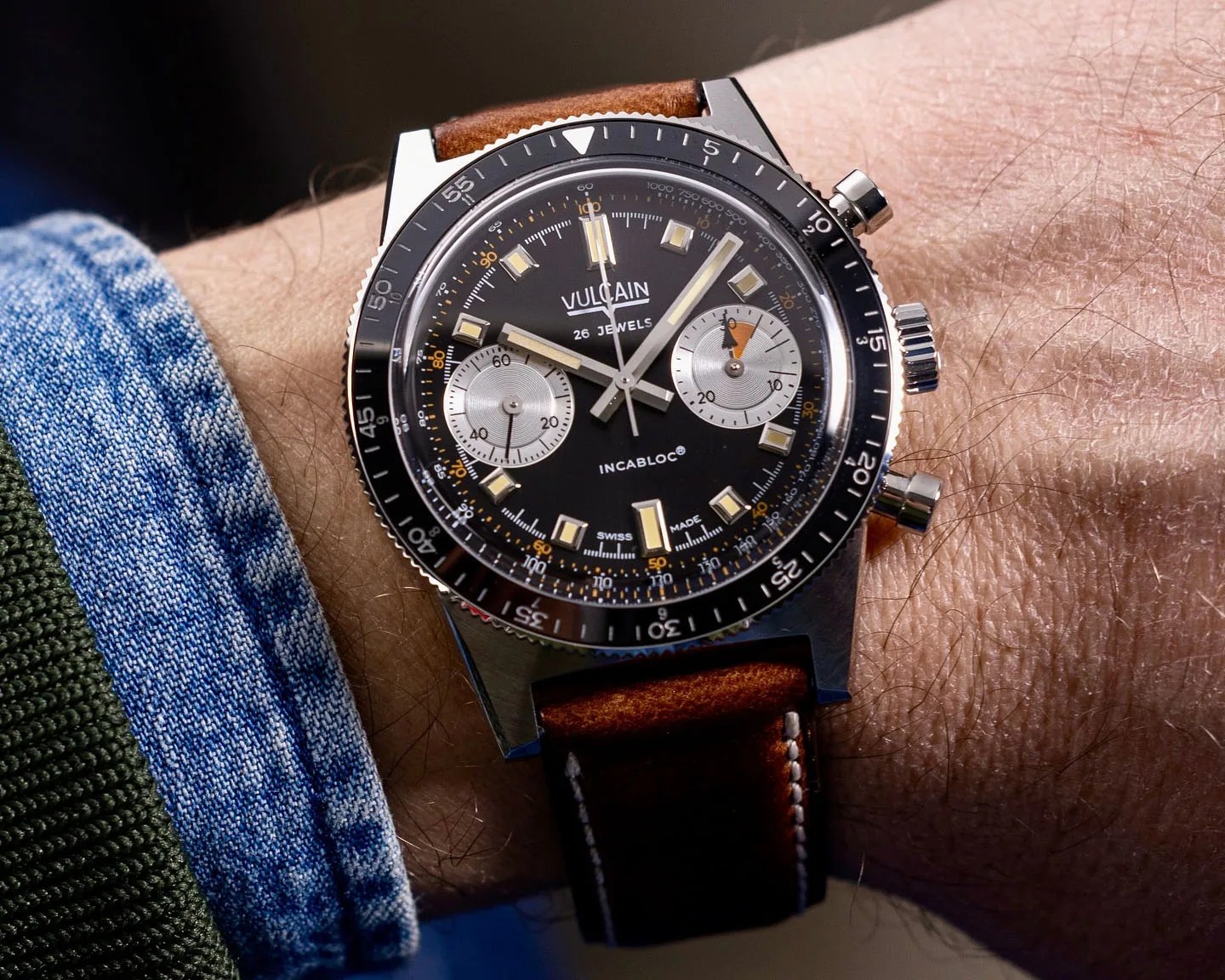 a black chronograph dive watch on a man's wrist
