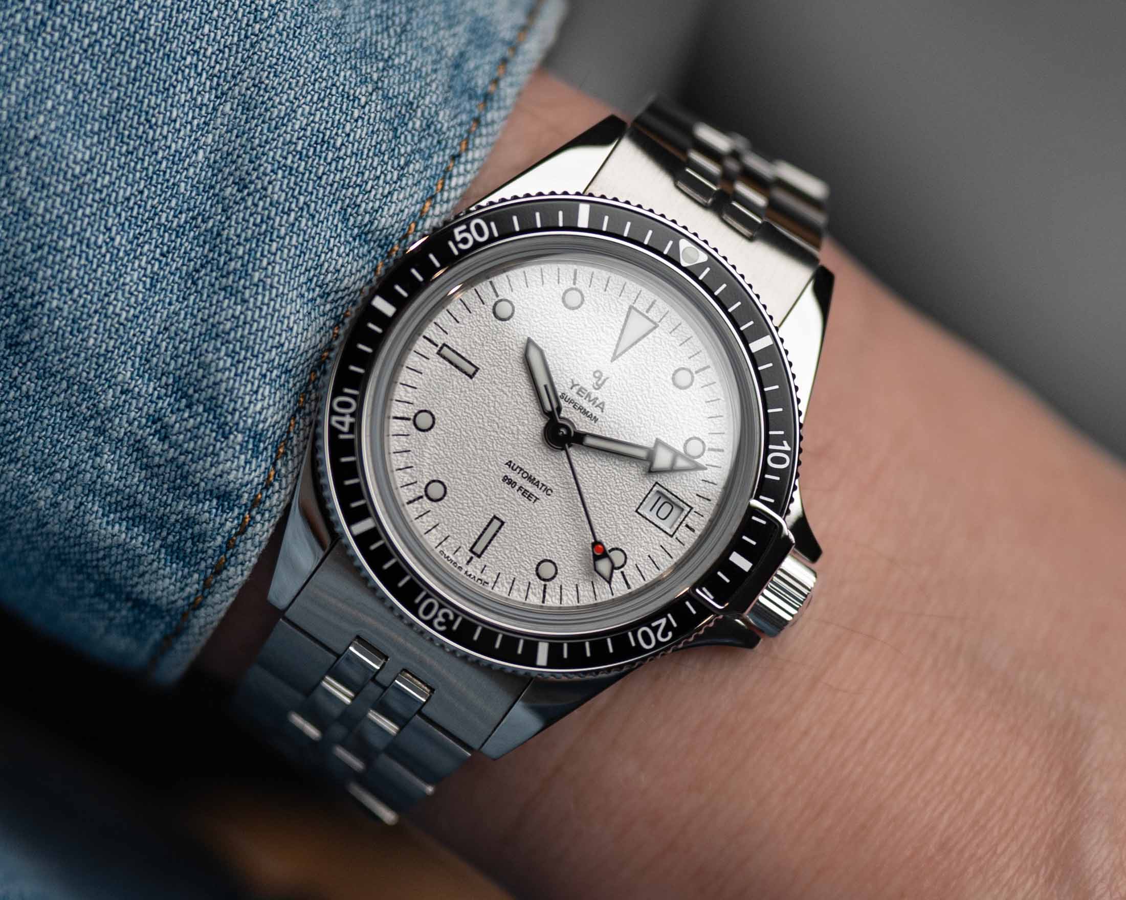 a steel dive watch with a white dial