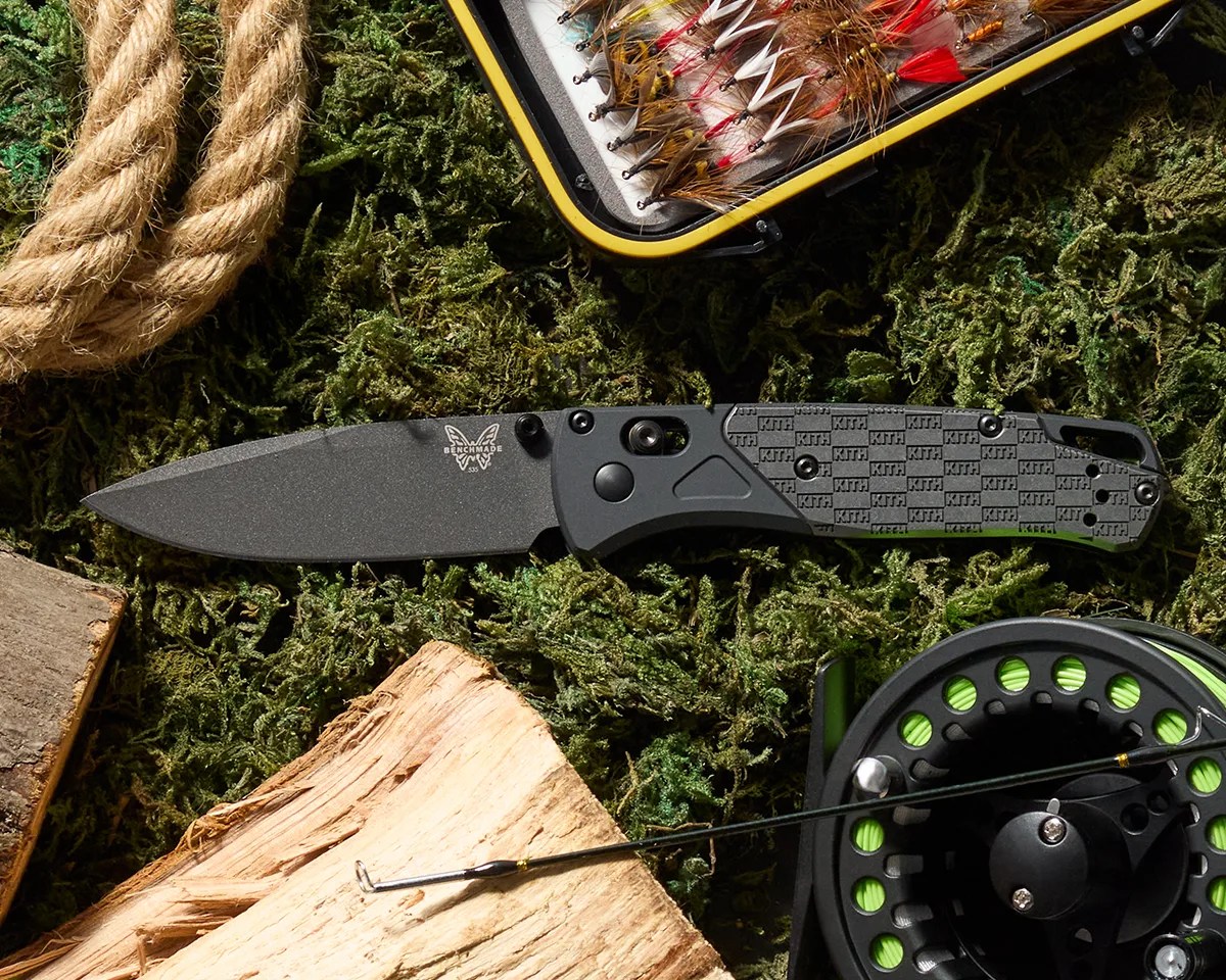 Benchmade BKC x Kith Bugout 535BK 2501 knife on grass next to fishing grear and wood