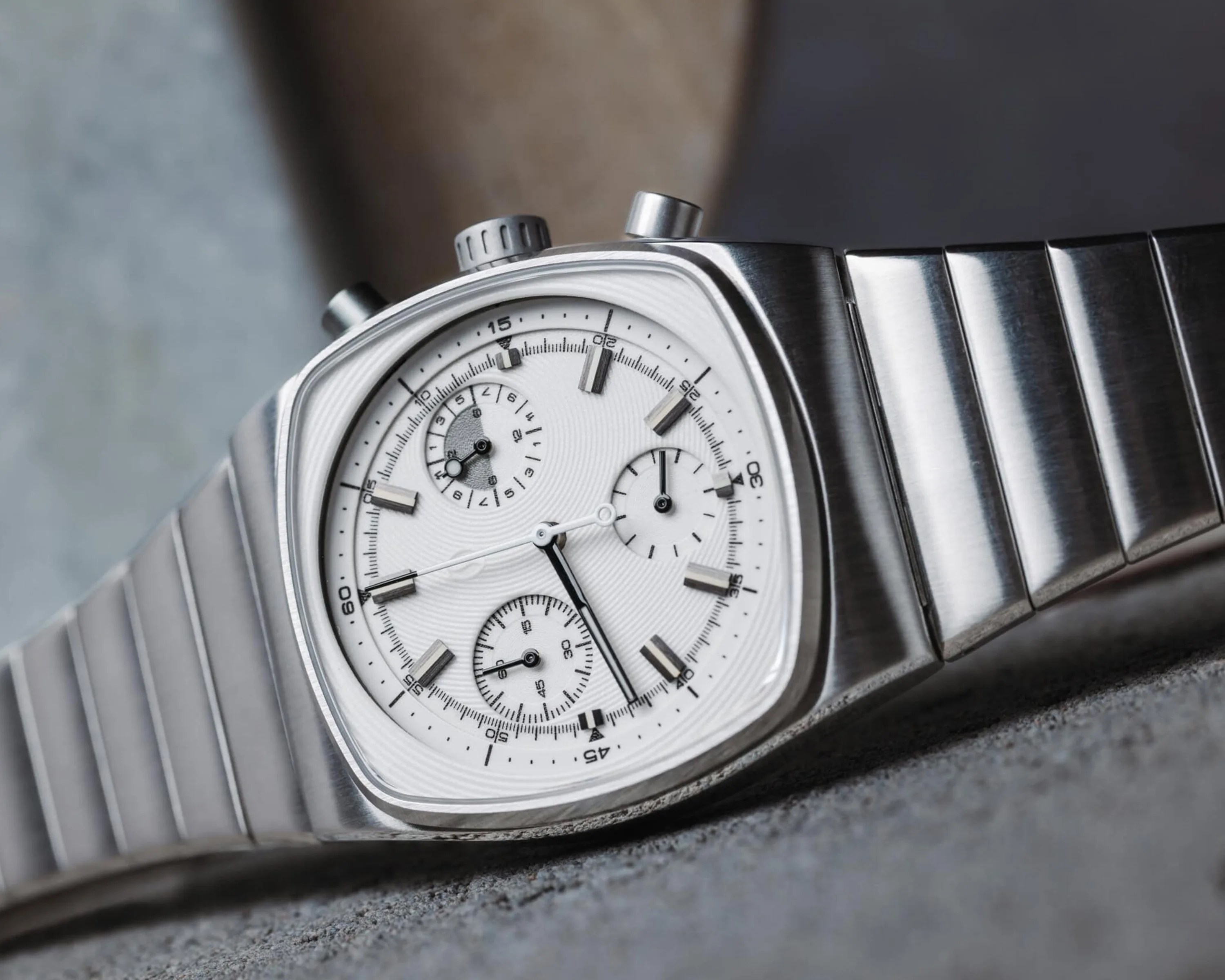 Brew x Worn and Wound Metric Chrono Regulator Lumint lying on cement