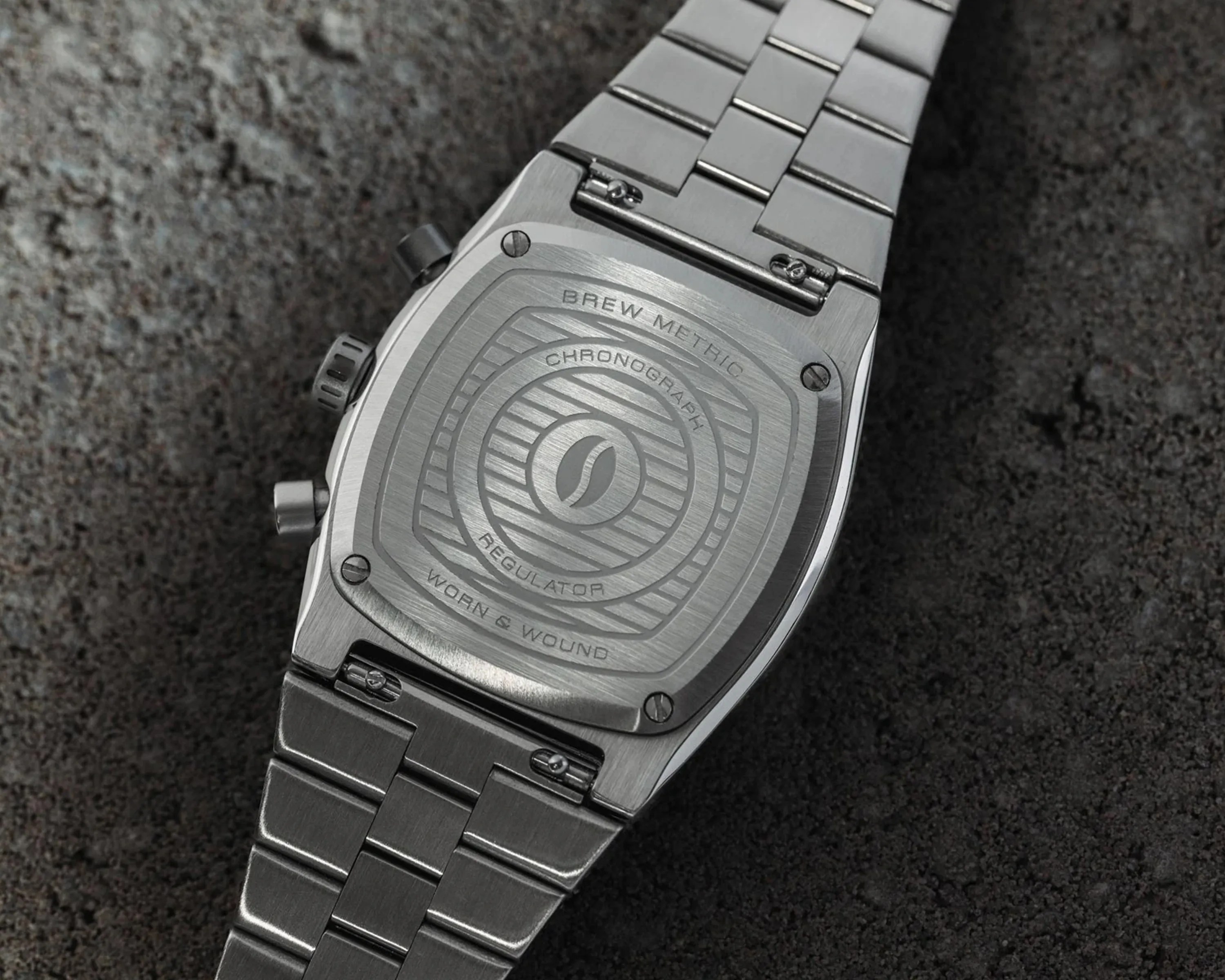 Brew x Worn and Wound Metric Chrono Regulator Lumint caseback on cement