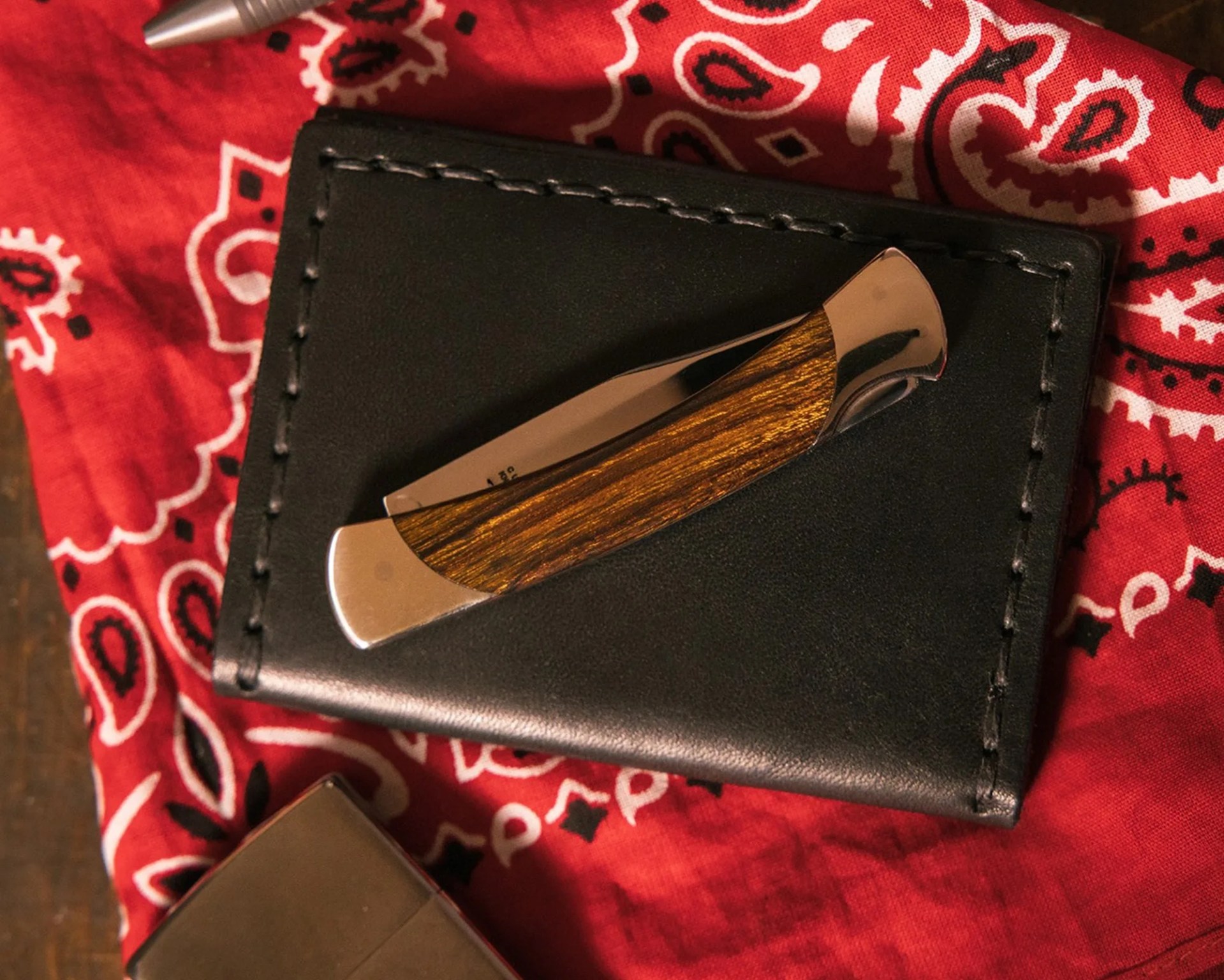 Buck The 55 Knife Custom on wallet and bandana next to zippo lighter