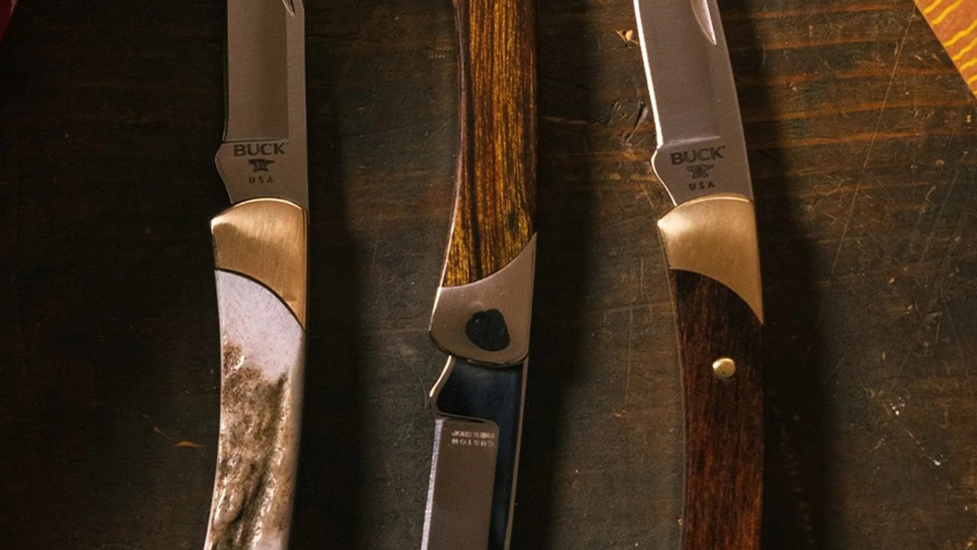 Closeup of three Buck The 55 Knife Customs