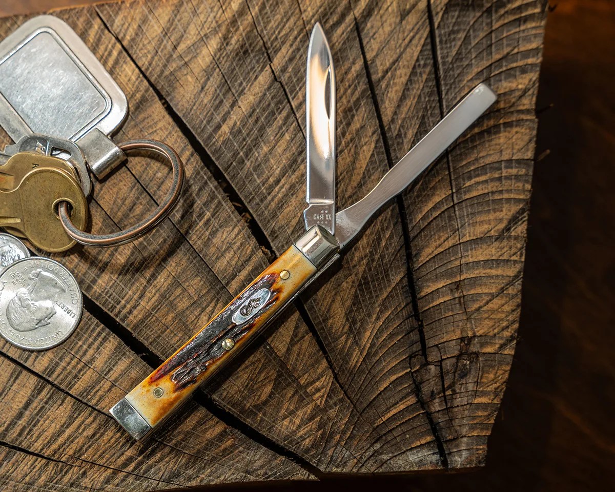 Case Baby Doc knife on log next to keys and change