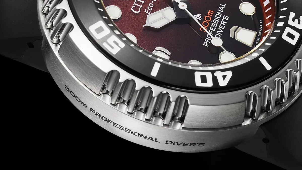 Closeup of Citizen Eco-Drive Professional Diver 300m watch case on red-black background