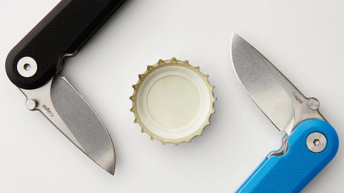 Two Craighill G10 Lark Knives around bottlecap