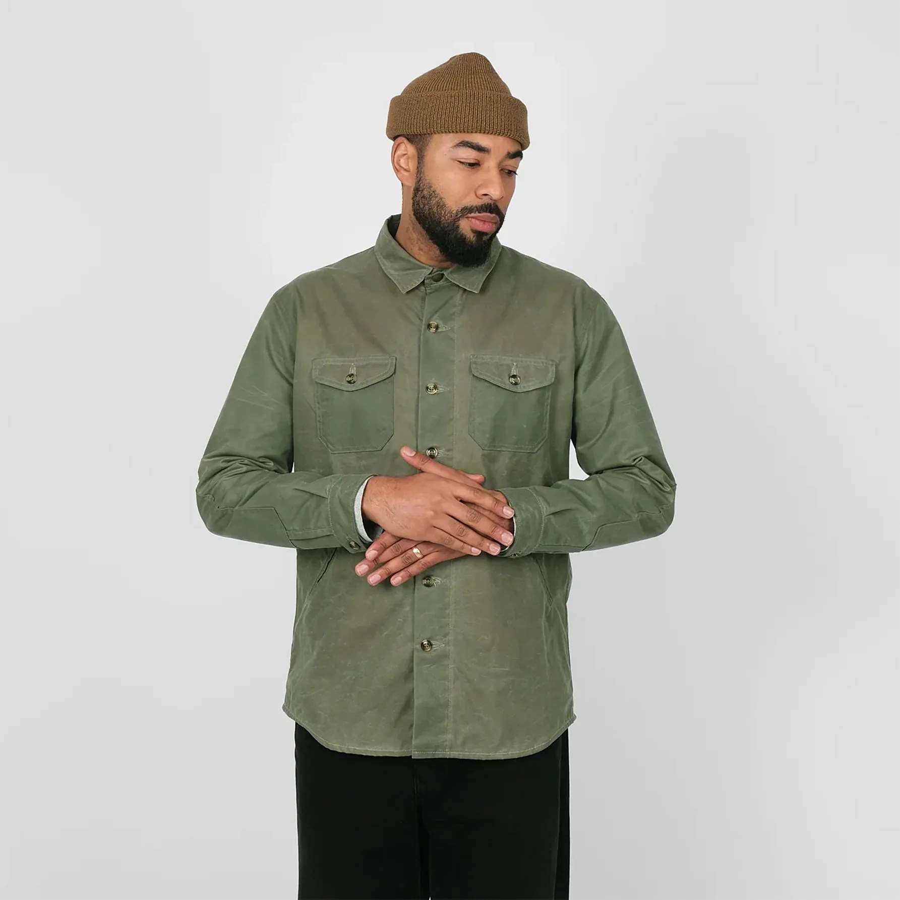 a man in a green shirt jacket and beanie