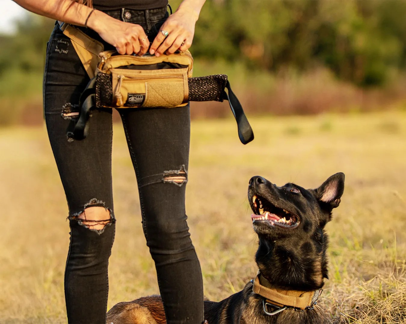 woman standing next to her dog wearing a her Ray Allen Manufacturing Dog Trainer Fanny Pack