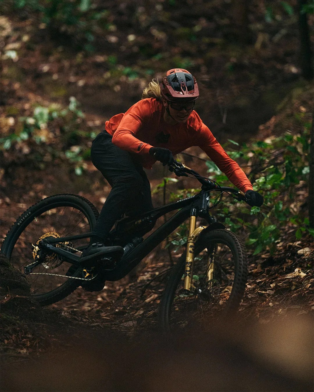 man riding bike through forest wearing Fox Racing Speedframe RS Helmet
