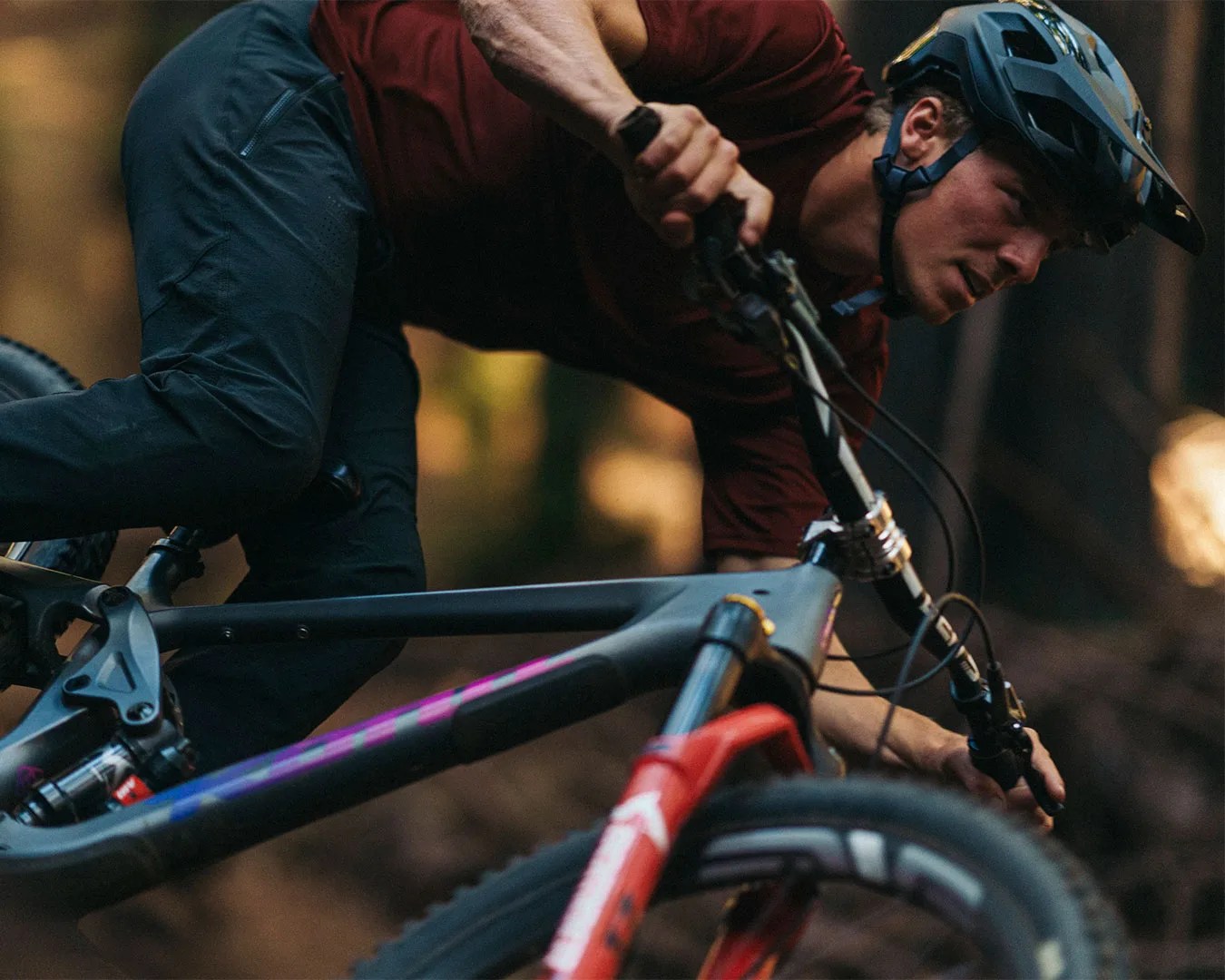 man riding bike through forest wearing Fox Racing Speedframe RS Helmet
