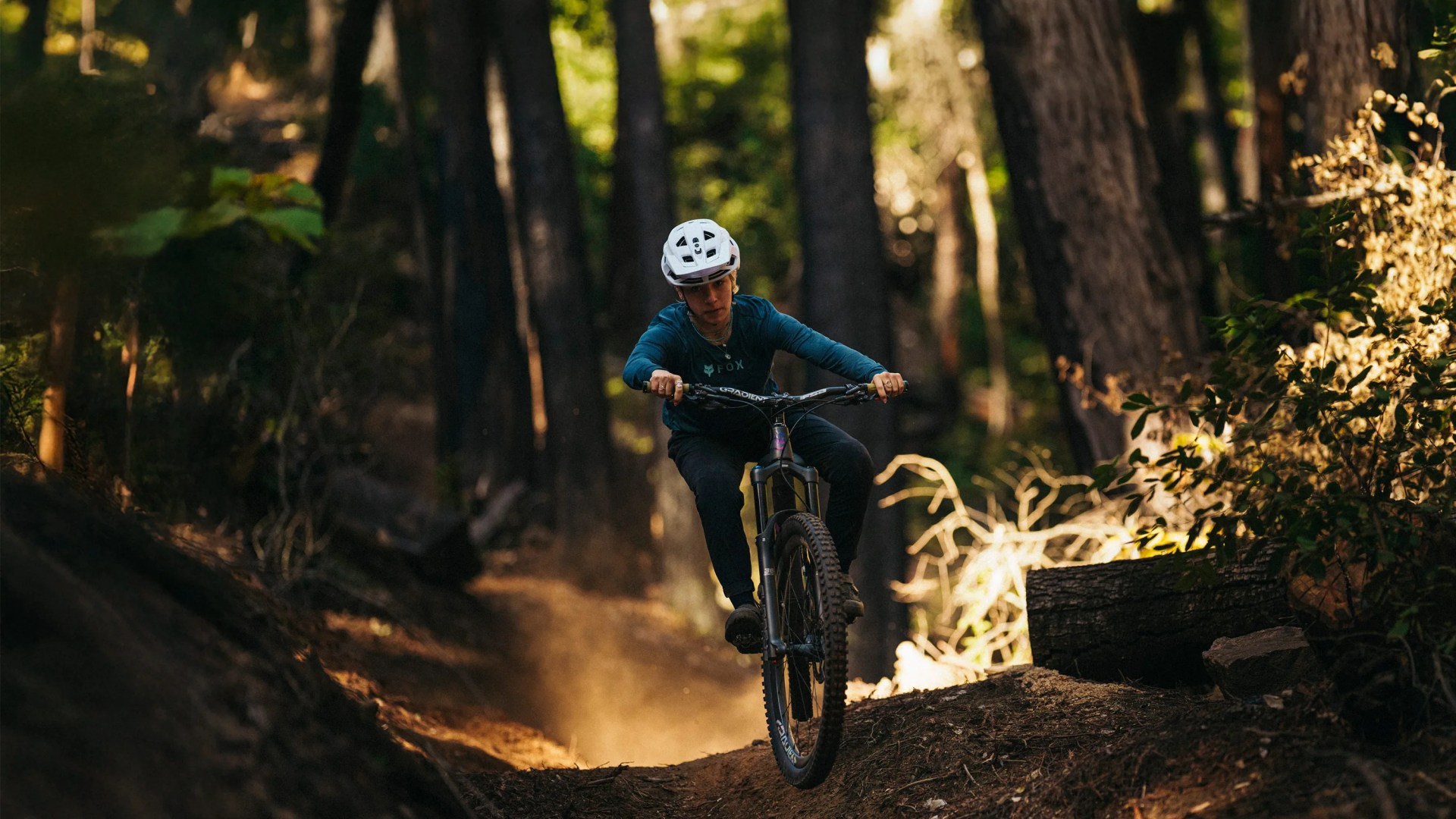 mountain bike riding in forest with helmet on