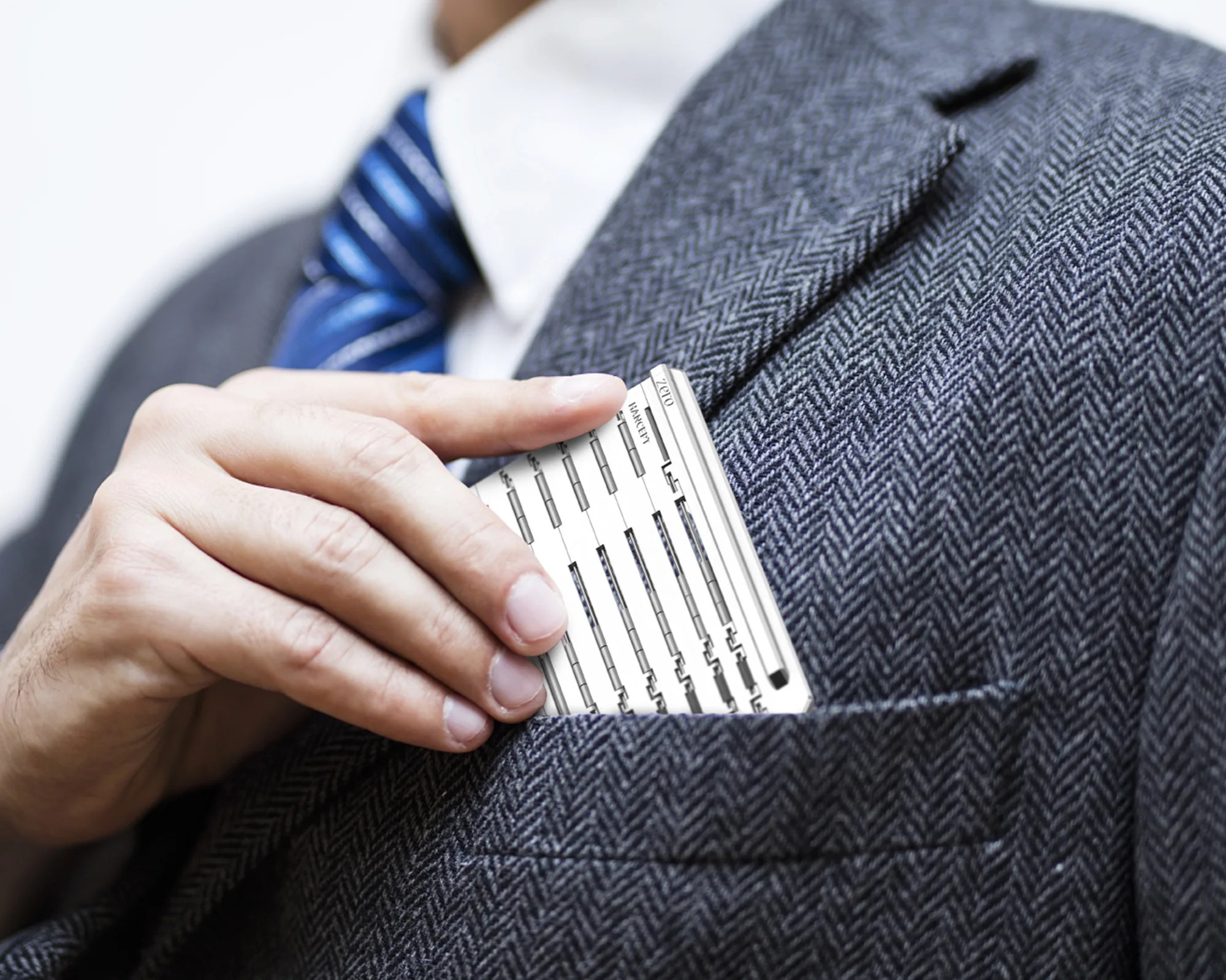 Hancept Zero Mk2 EDC Pen being put in suit jacket front pocket