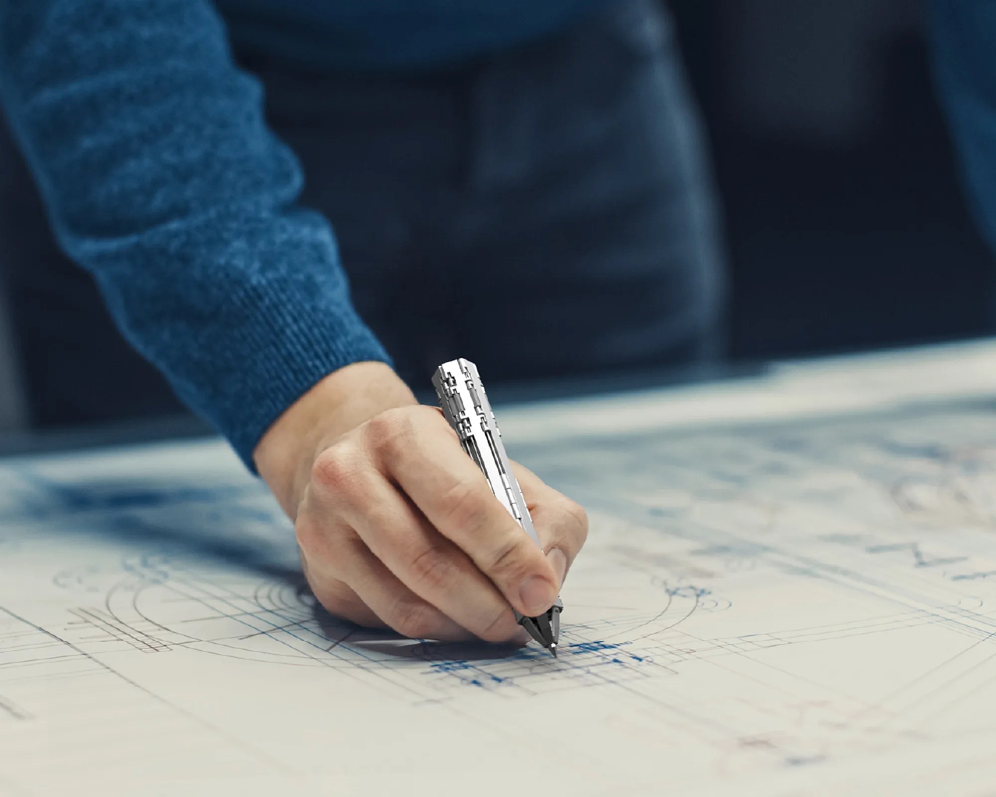 Hancept Zero Mk2 EDC Pen in hand on blueprints