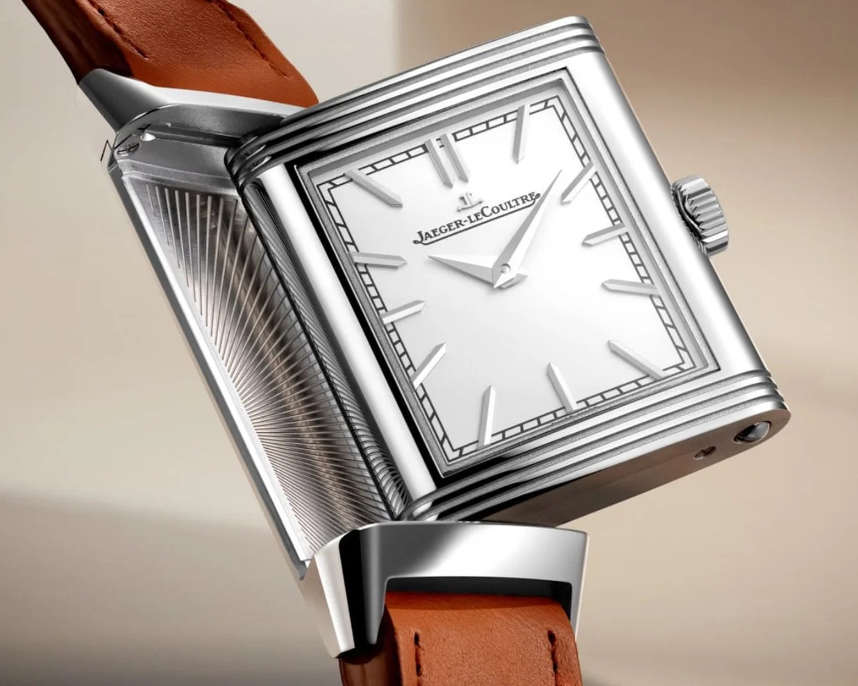 a Jaeger-LeCoultre reverso watch being turned