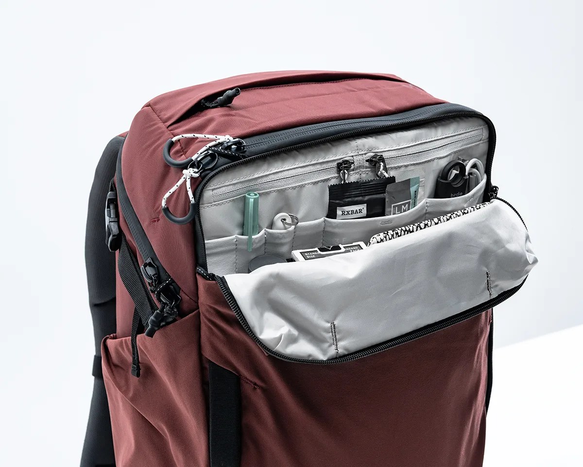 Front pocket of Matador GlobeRider35 Travel Backpack open with assorted items inside