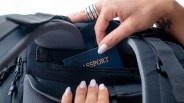 Closeup of Matador GlobeRider35 Travel Backpack passport pocket with passport and woman's hands