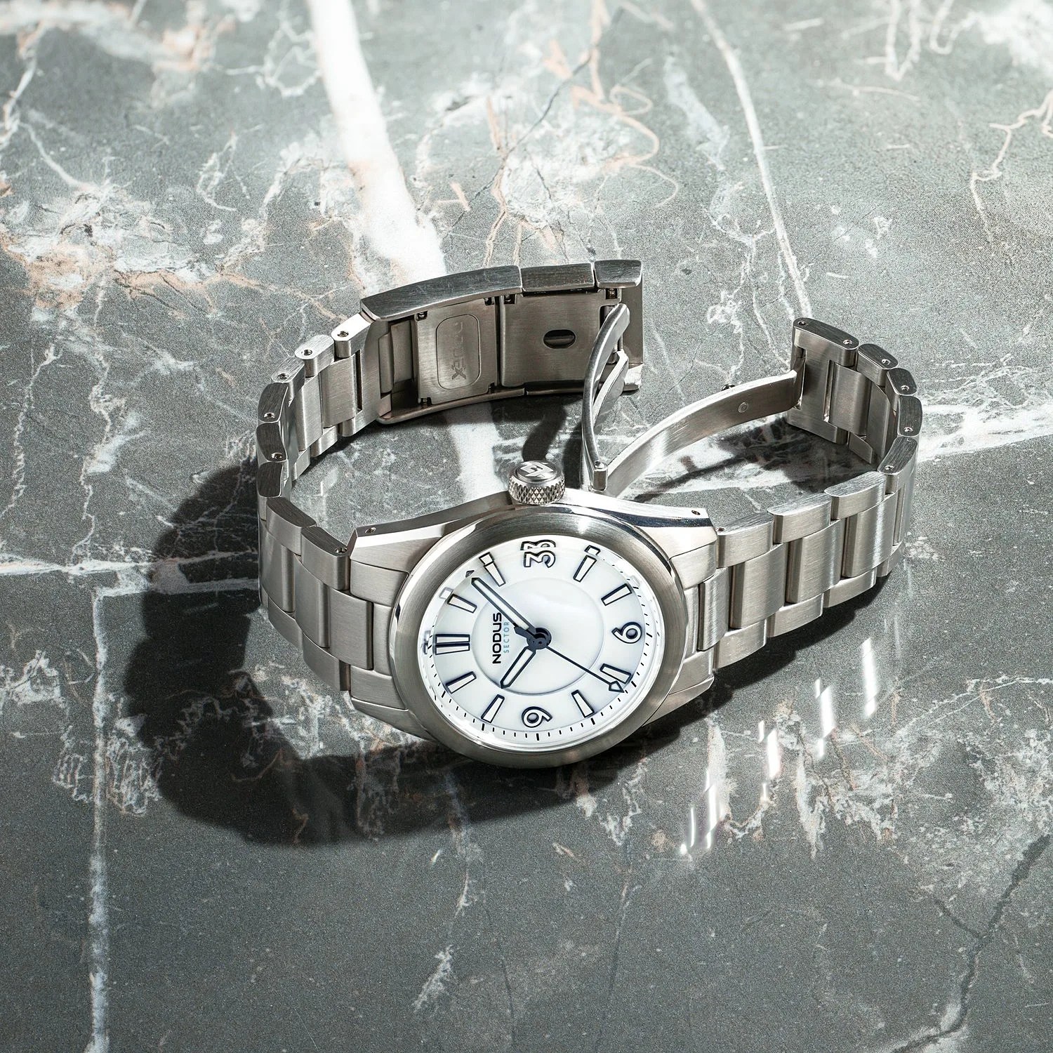 a steel watch with a white dial