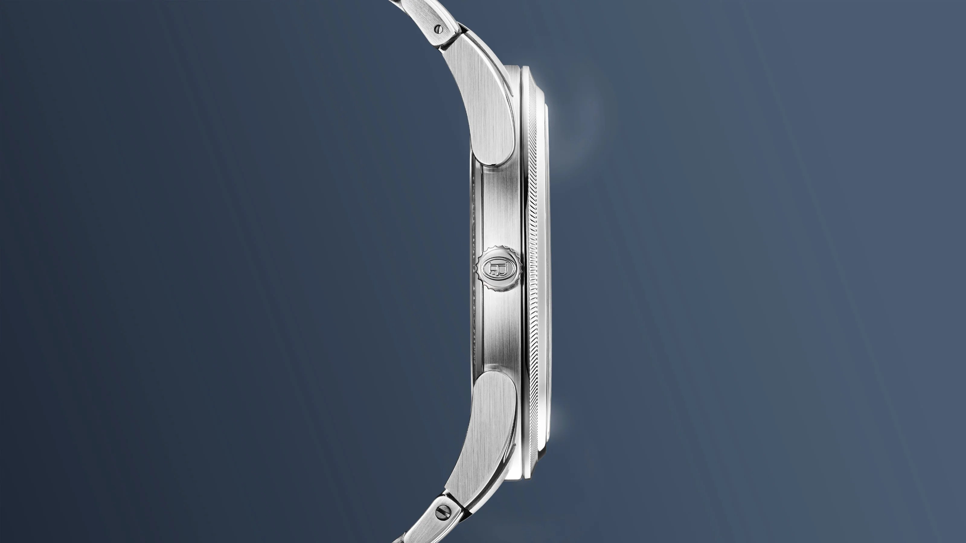 A profile view of the Parmigiani PF Micro-Rotor Platinum Stone Blue against a blue gradient background
