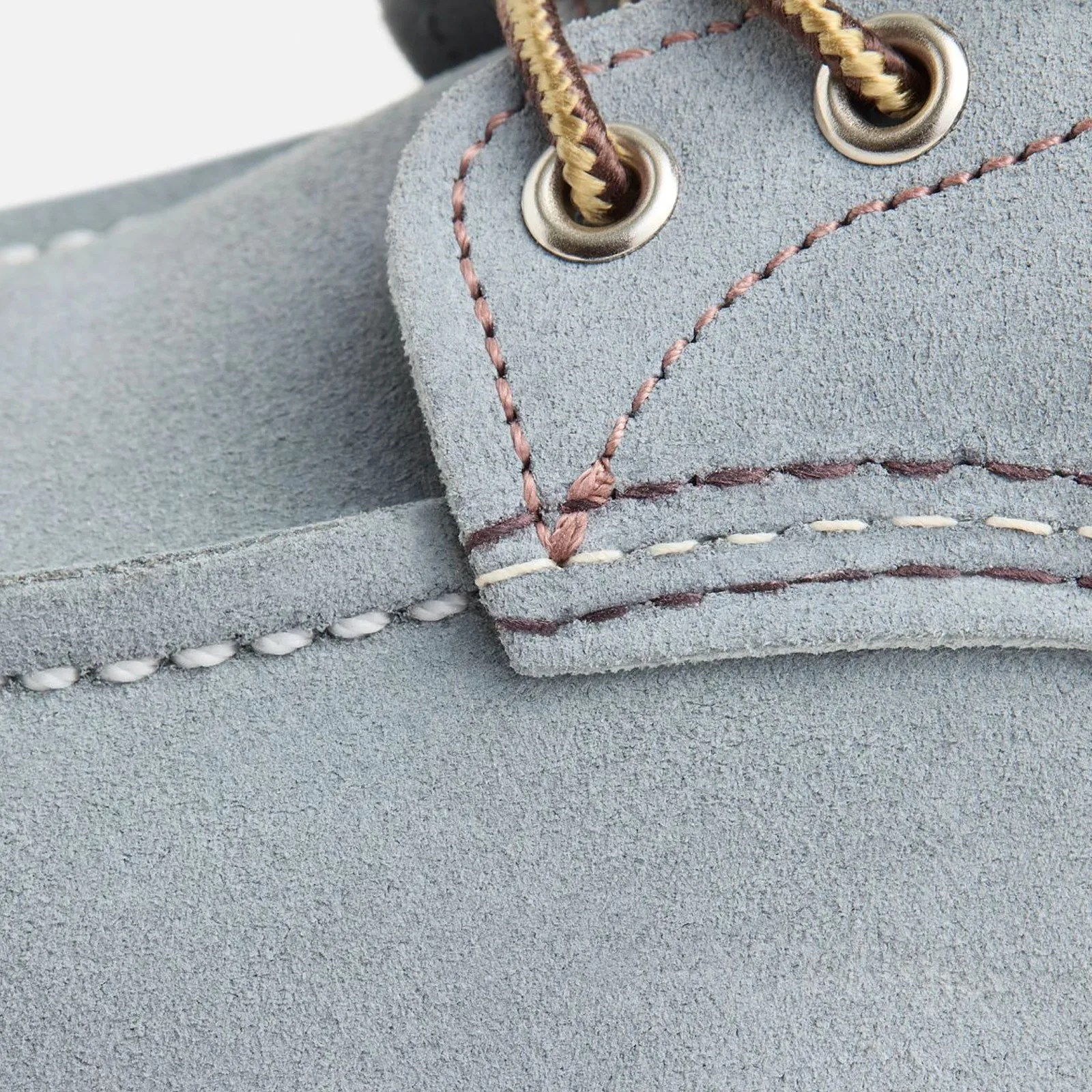 A close-up detailed shot of the Red Wing Classic Moc Bott style 8800 in Dusty Blue. The image clearly shows the suede-like texture of the Roughout leather as well as the boots metal eyelets. 