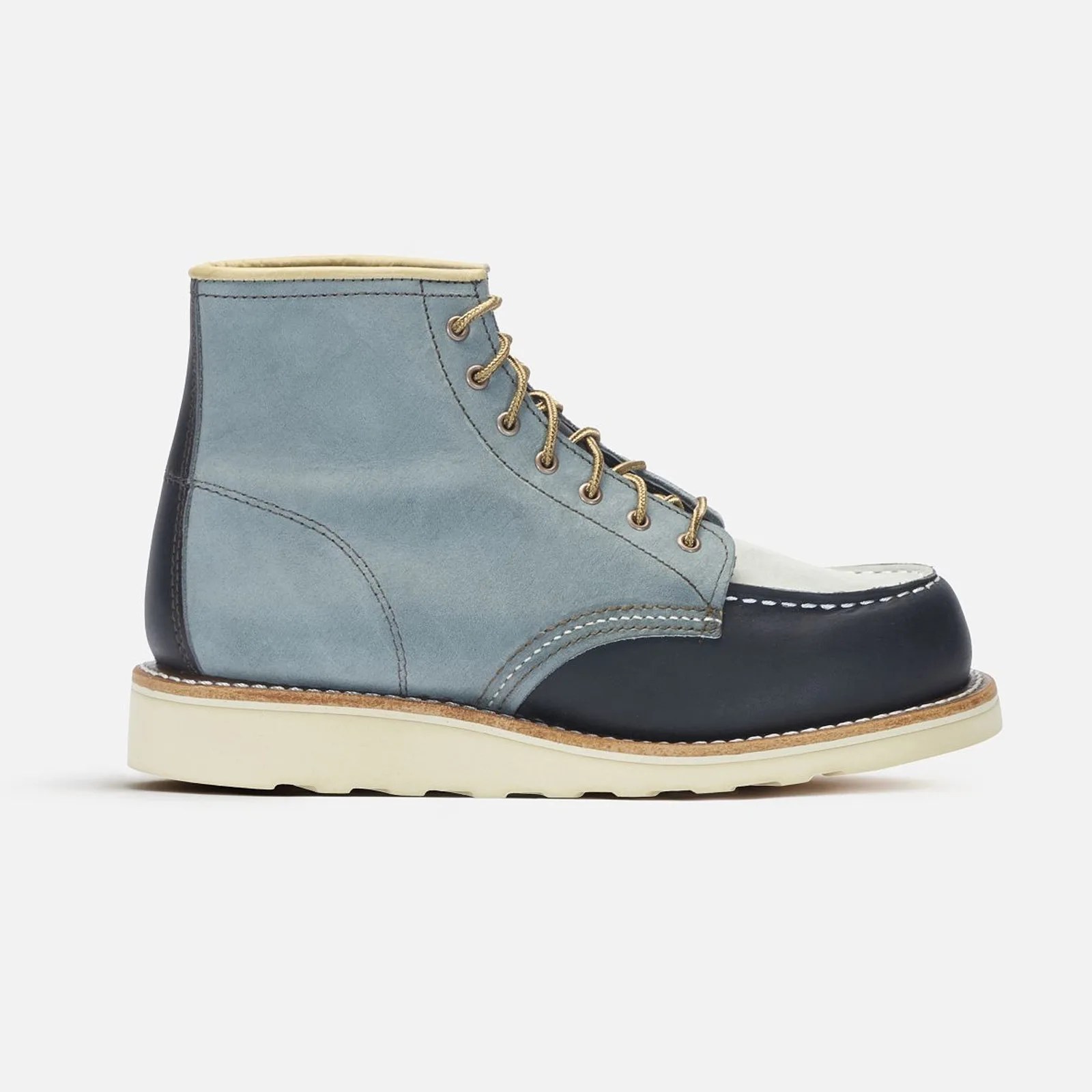 A single Red Wing Heritage women's The Great Boot in multi-indigo color. The color is a combination of two shades of blue. The toe area and heel stripe appear made from a dark navy oiled leather. The sides of the boot appear made from a lighter blue leather of a different texture. The tongue and top toe area appear white. 

The toe of the boot is pointing to the left of the image frame. The boot is sitting against a light grey background. 