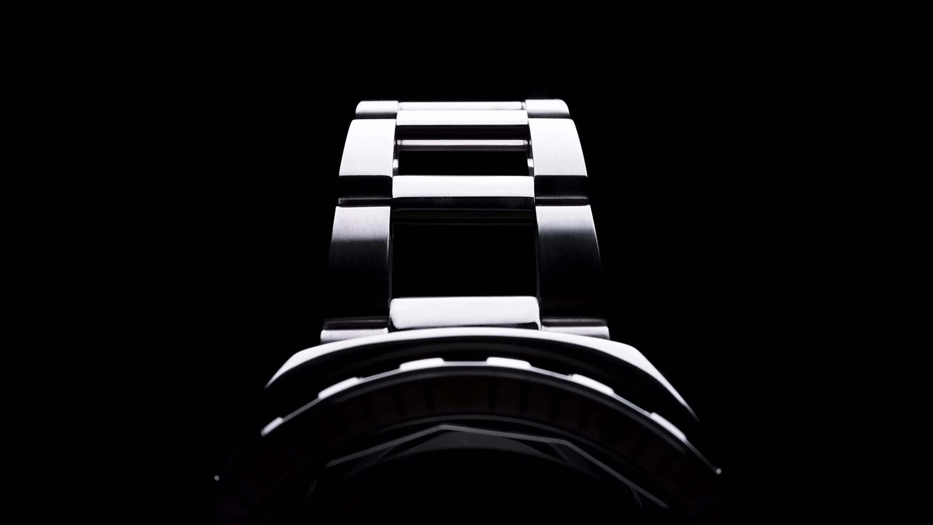 A teaser image of the Squale 2001 dive watch shown on a dark black background and shadowed