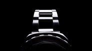 A teaser image of the Squale 2001 dive watch shown on a dark black background and shadowed