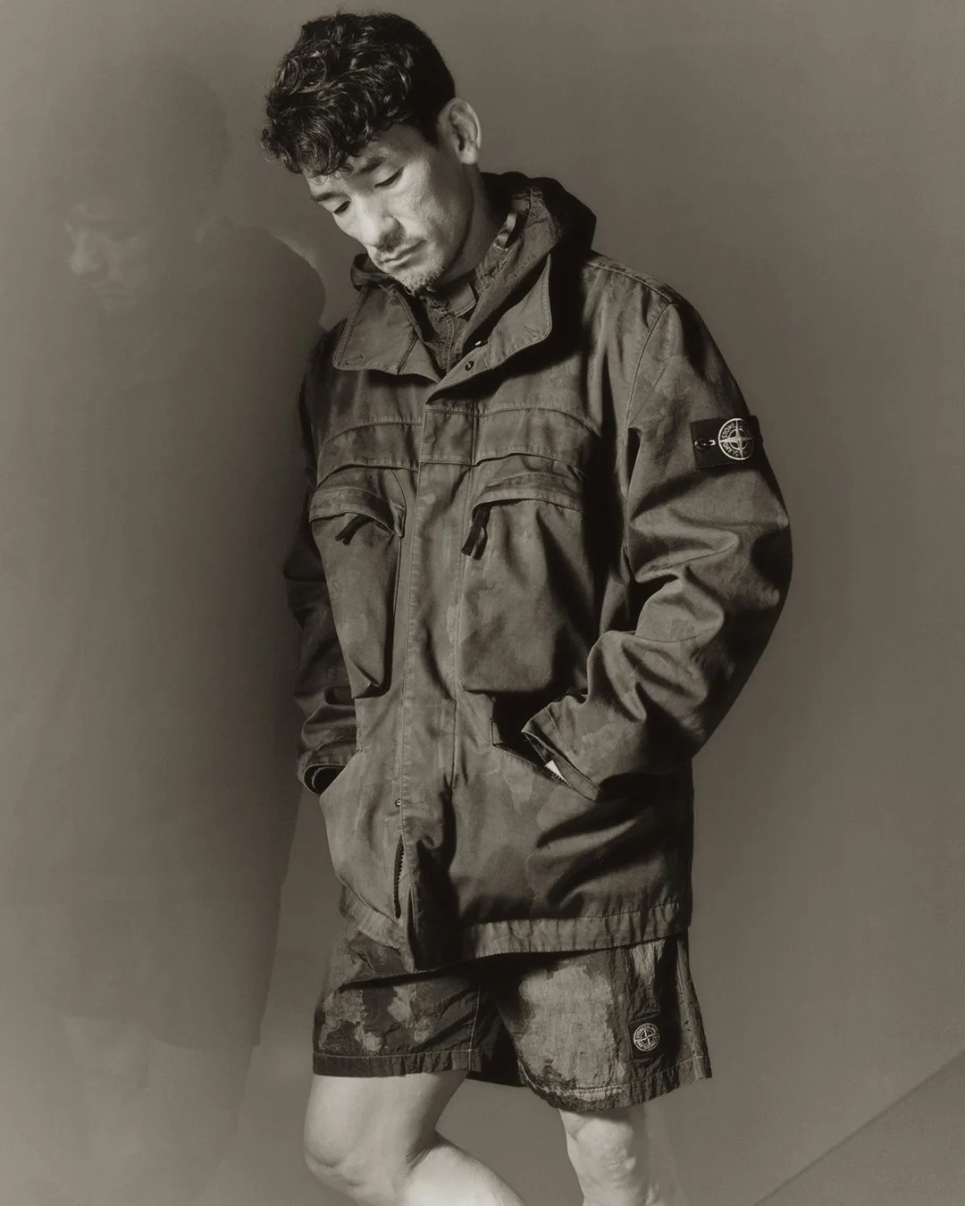 Model wearing Stone Island 4100022 Raso Gommato 3L Laser Camo Field Jacket