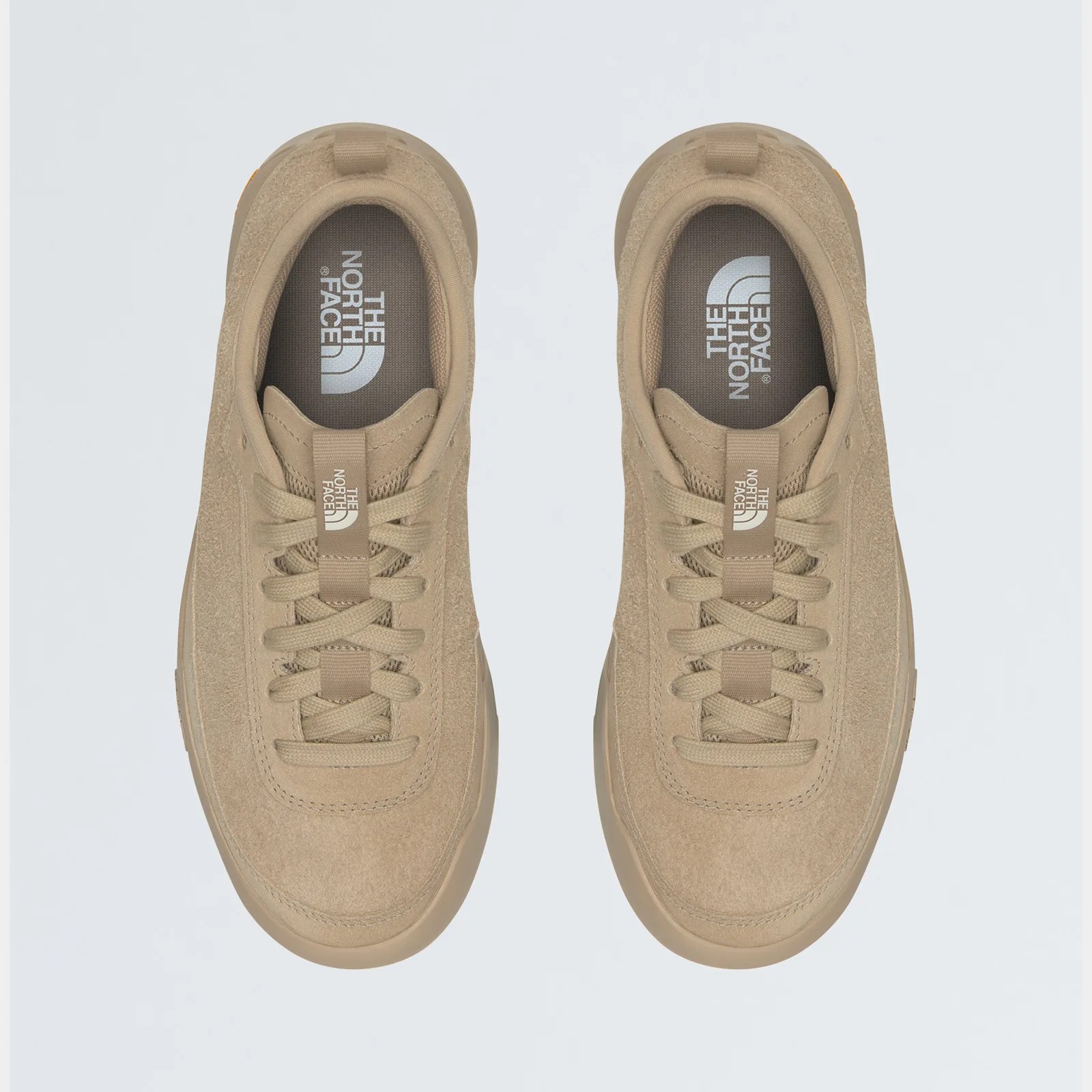A gods eye view of The North Face Clyffe in tan against a grey background. 