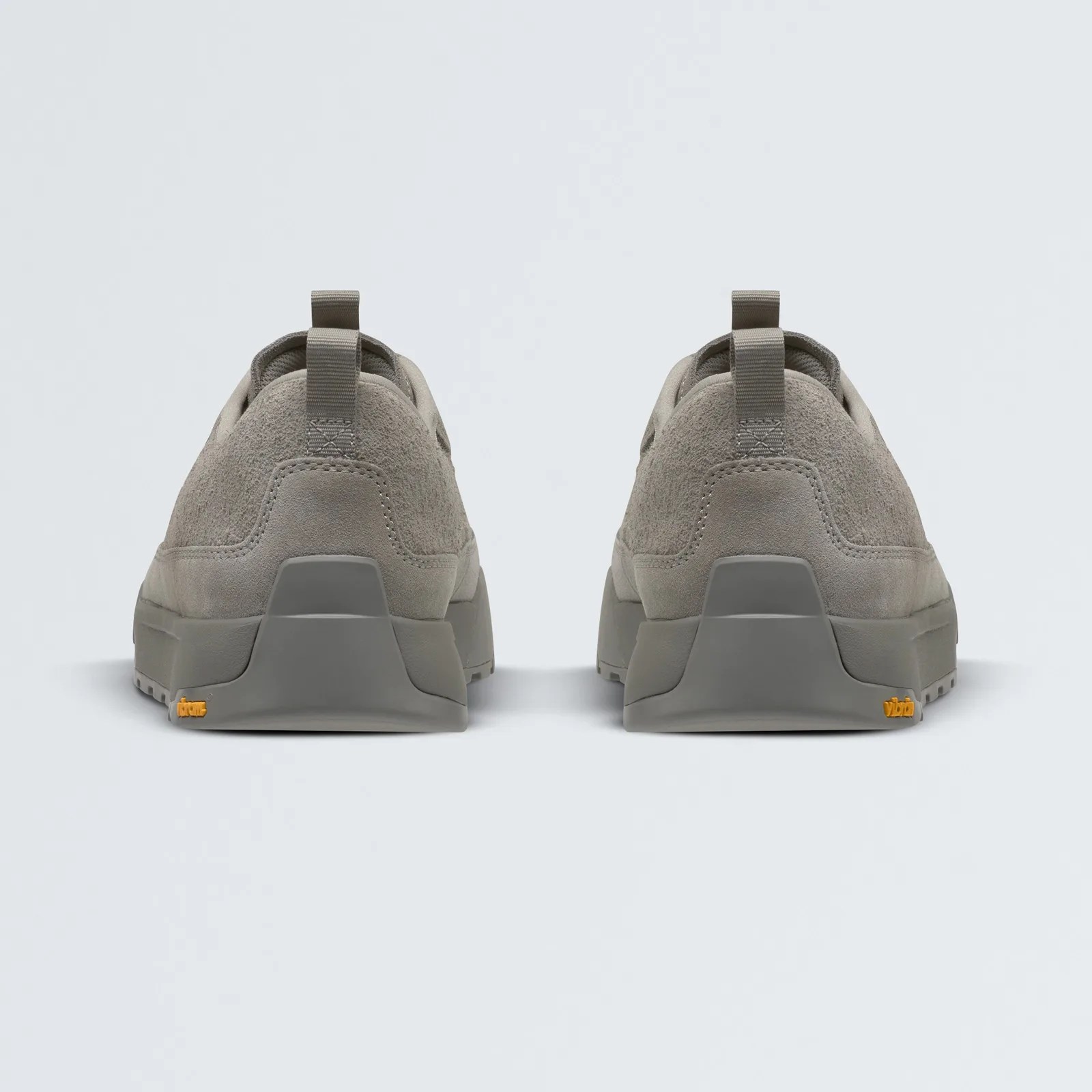 A view of the heel of a pair of Clyffe Suede Shoes in Stone Slab / Slate Rock with a light grey background.