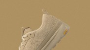 A view of the heel of The North Face Clyffe Suede Shoes shown at an angle against a speckled tan background
