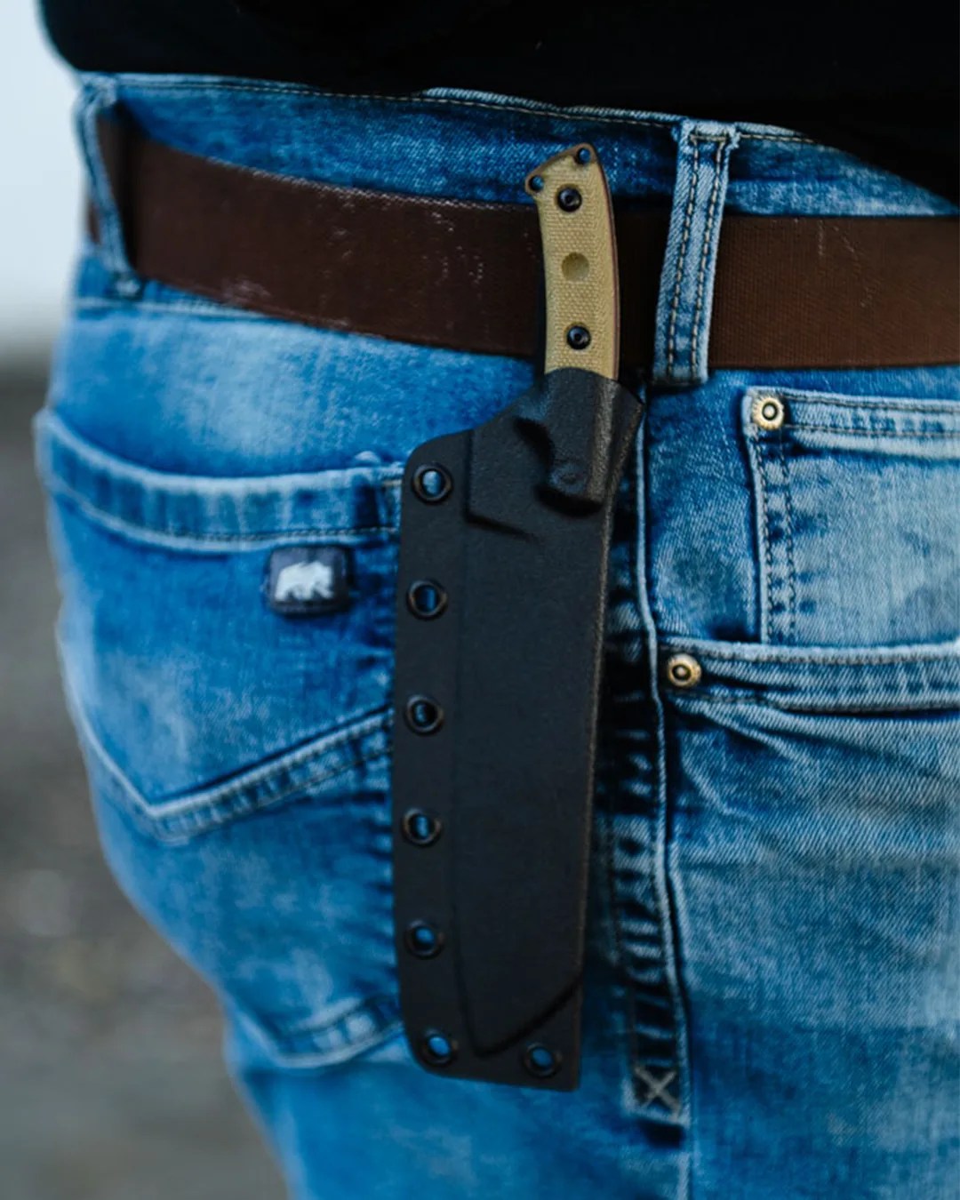 Tops Knives El Chete Mini in sheath on person's belt