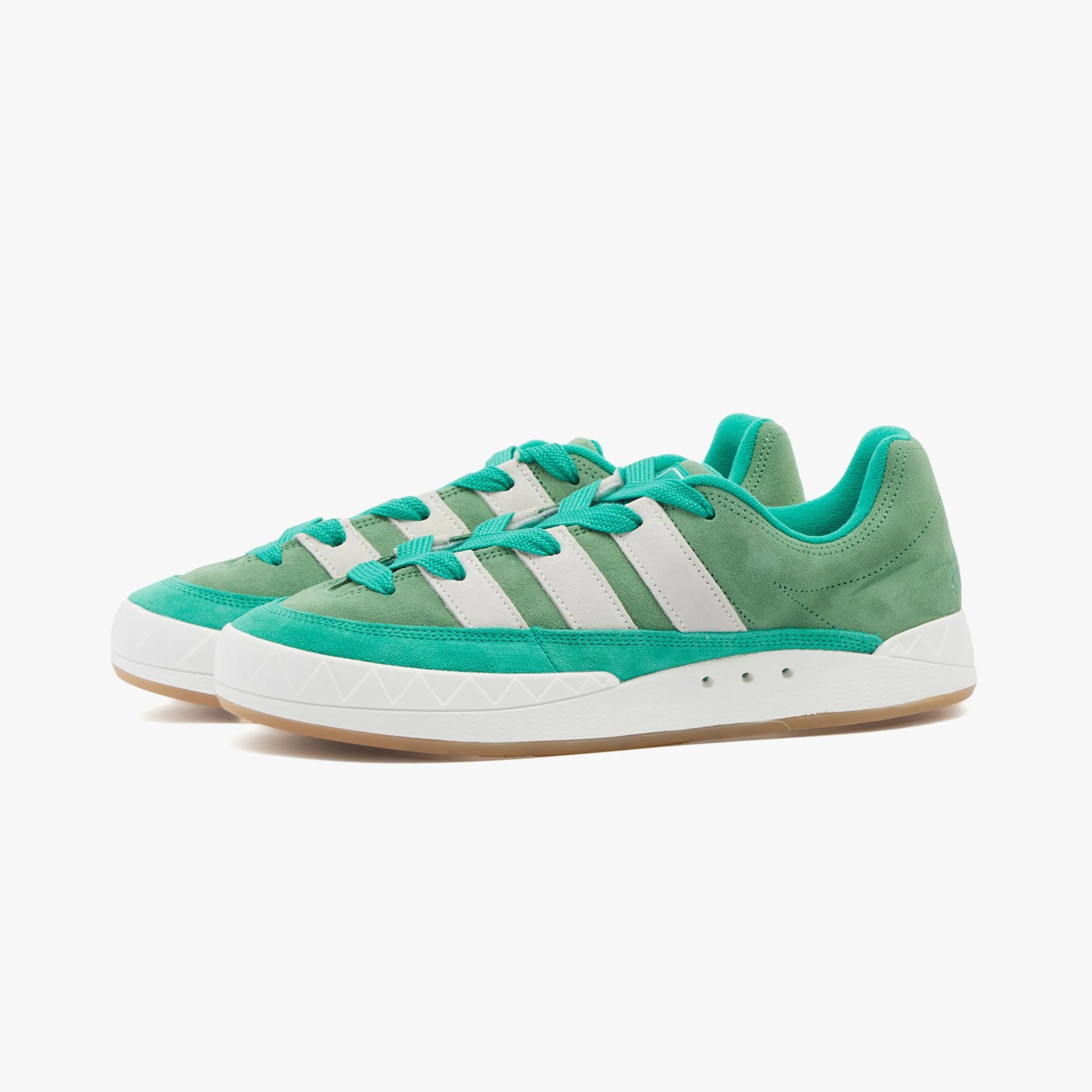 a pair of green adidas sneakers
