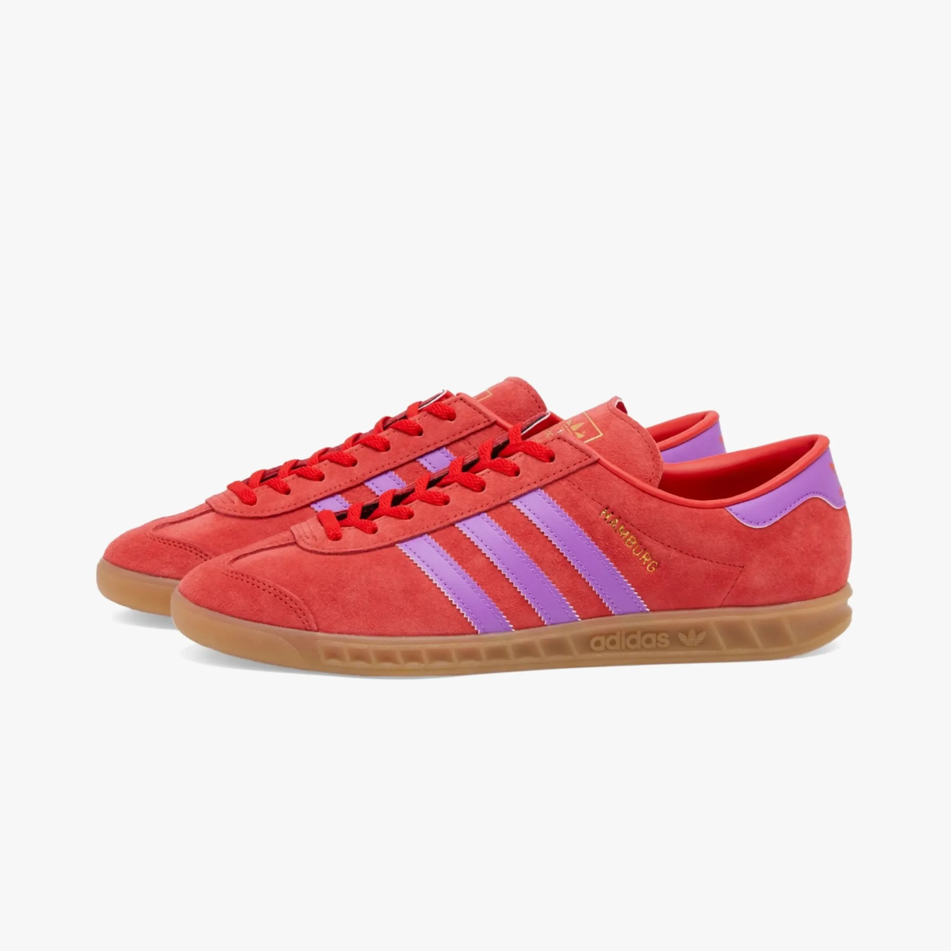 a pair of red adidas sneakers
