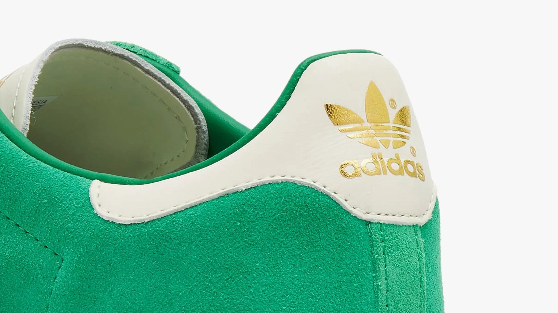 the heel of a green adidas sneaker