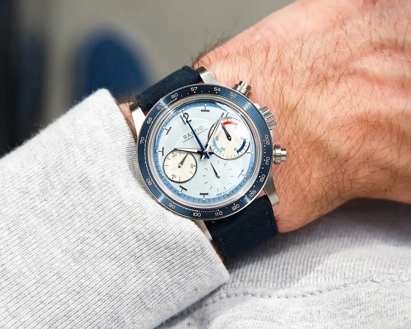 a Baltic chronograph with a blue suede strap on a man's wrist