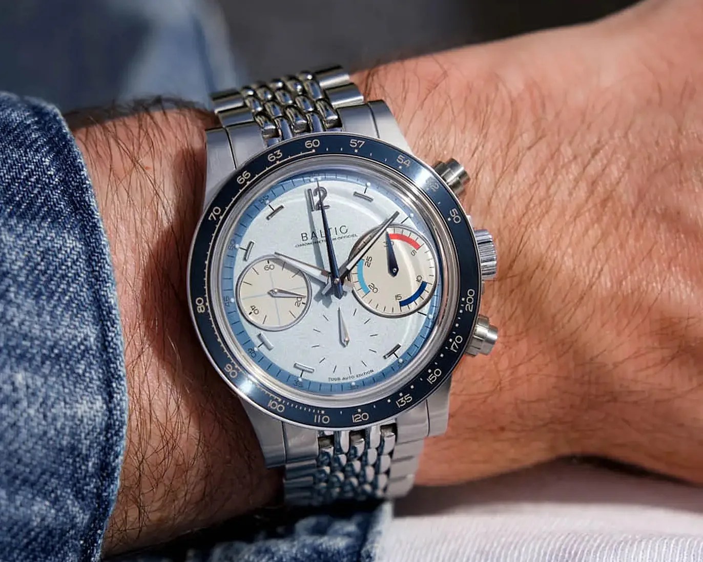 a blue Baltic chronograph on a man's wrist