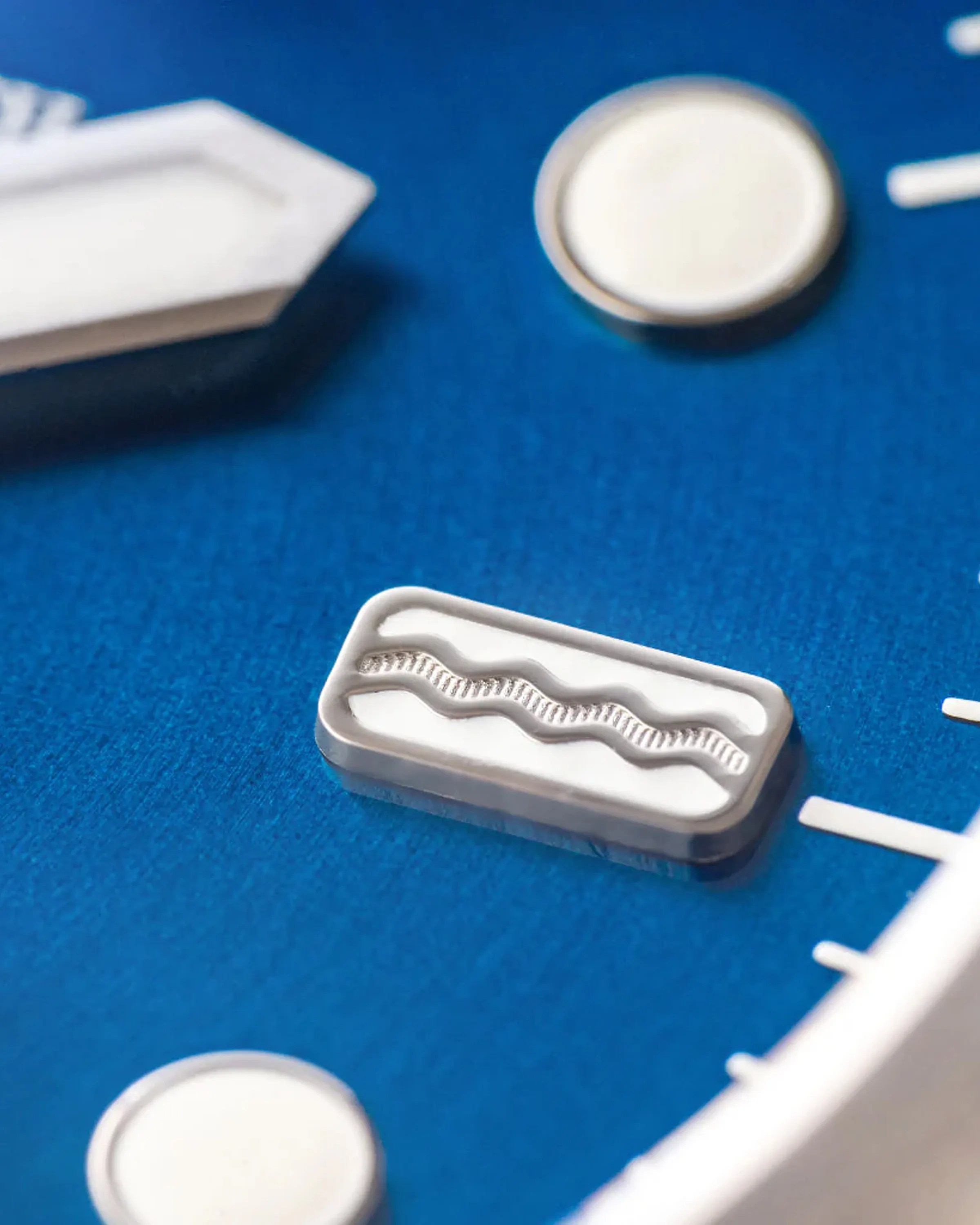 close up on the dial of a blue field watch
