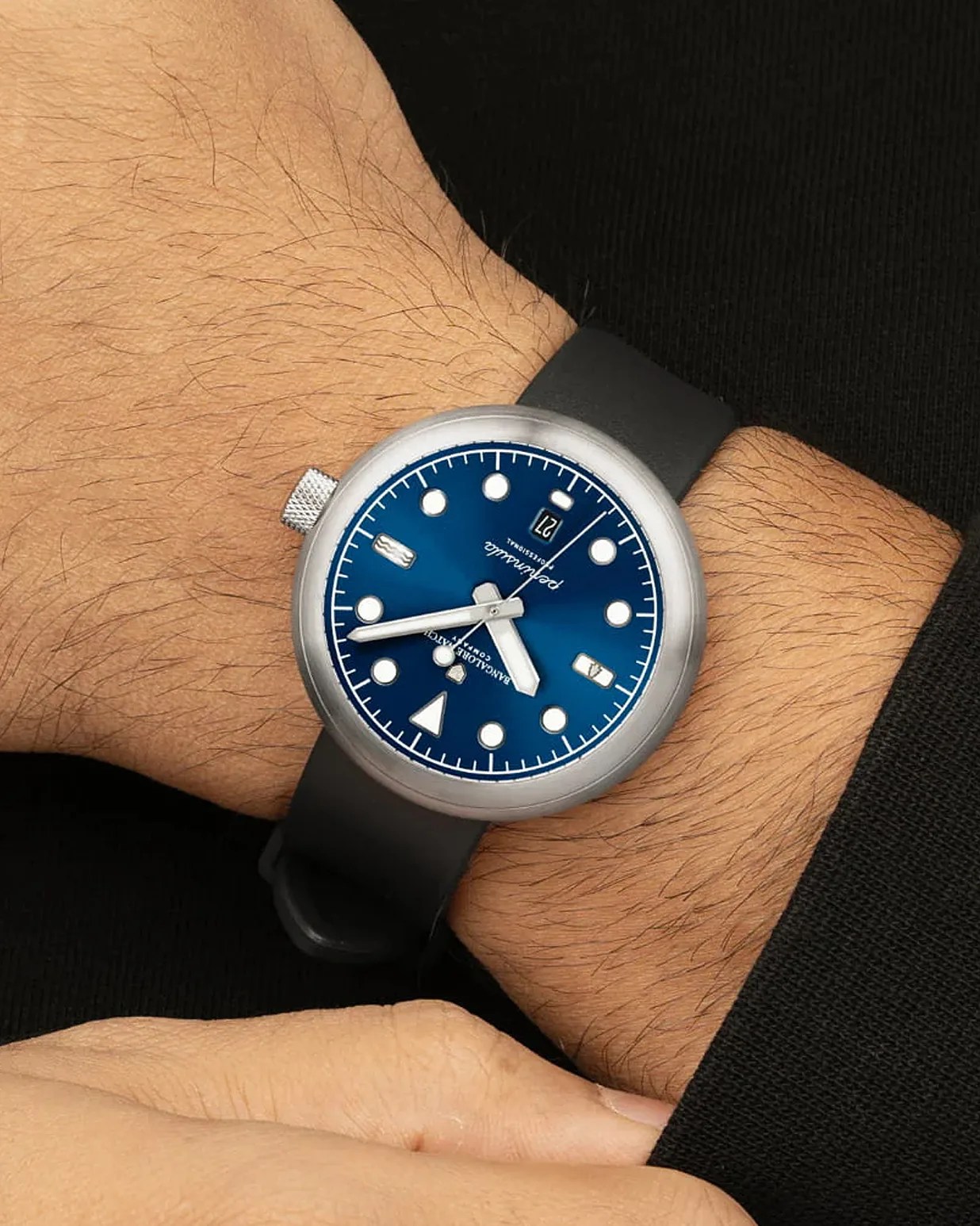 a blue field watch on a black leather strap