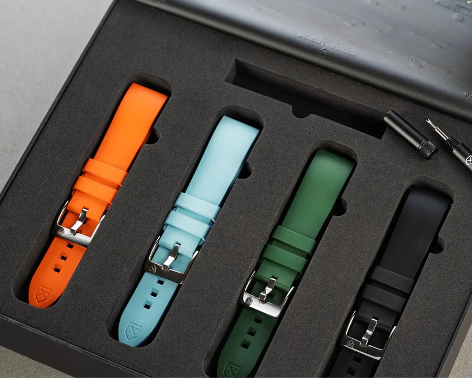a box of four different color watch straps