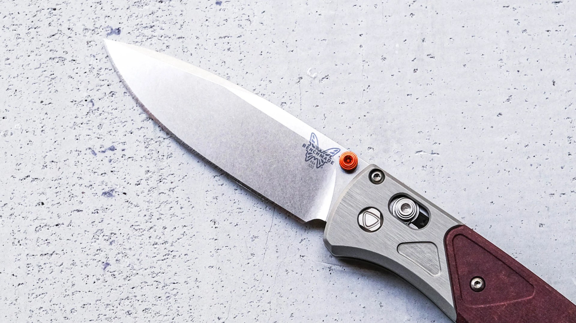 Benchmade Bugout Redstone knife blade on cement