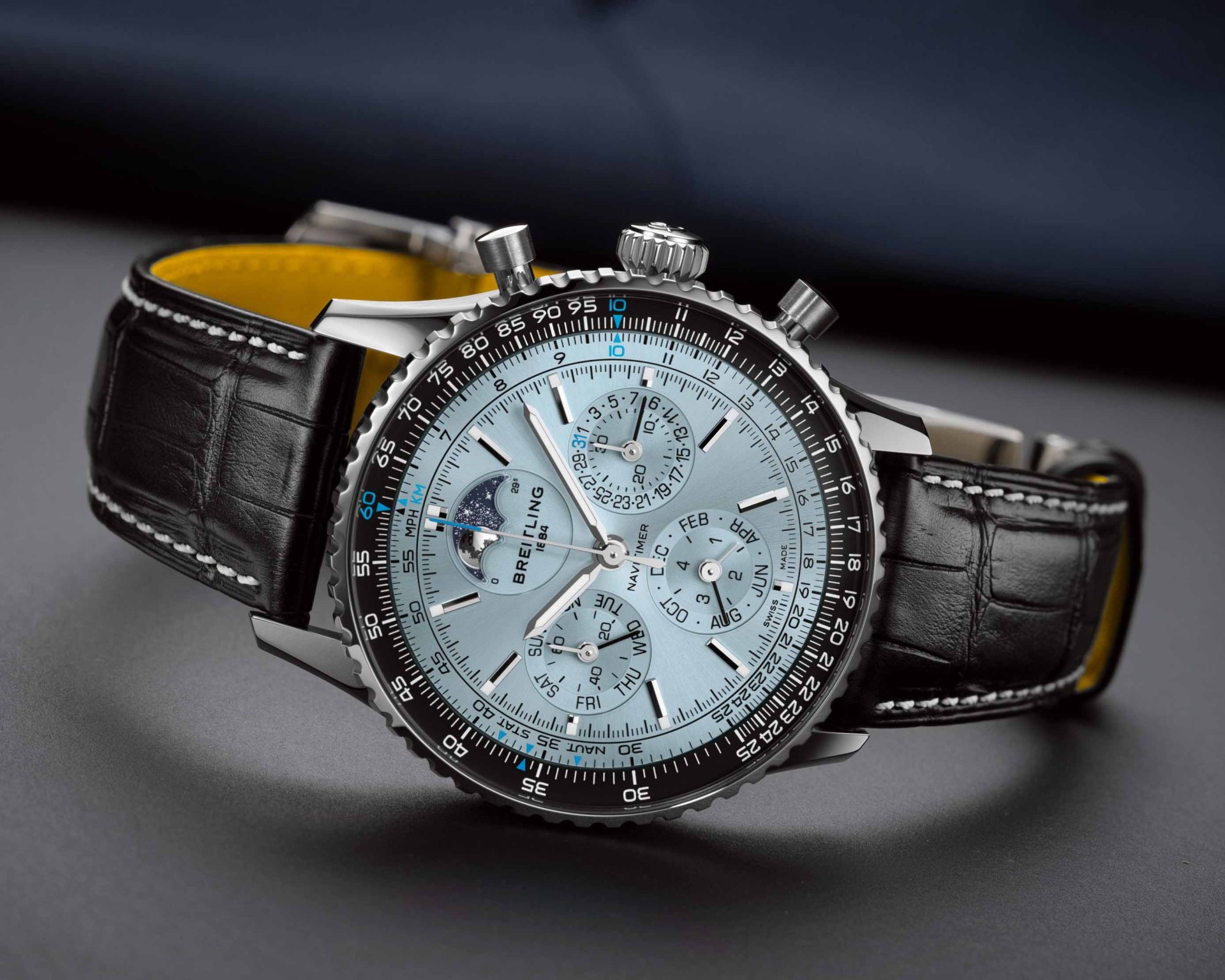 a light blue dial watch with a black leather band