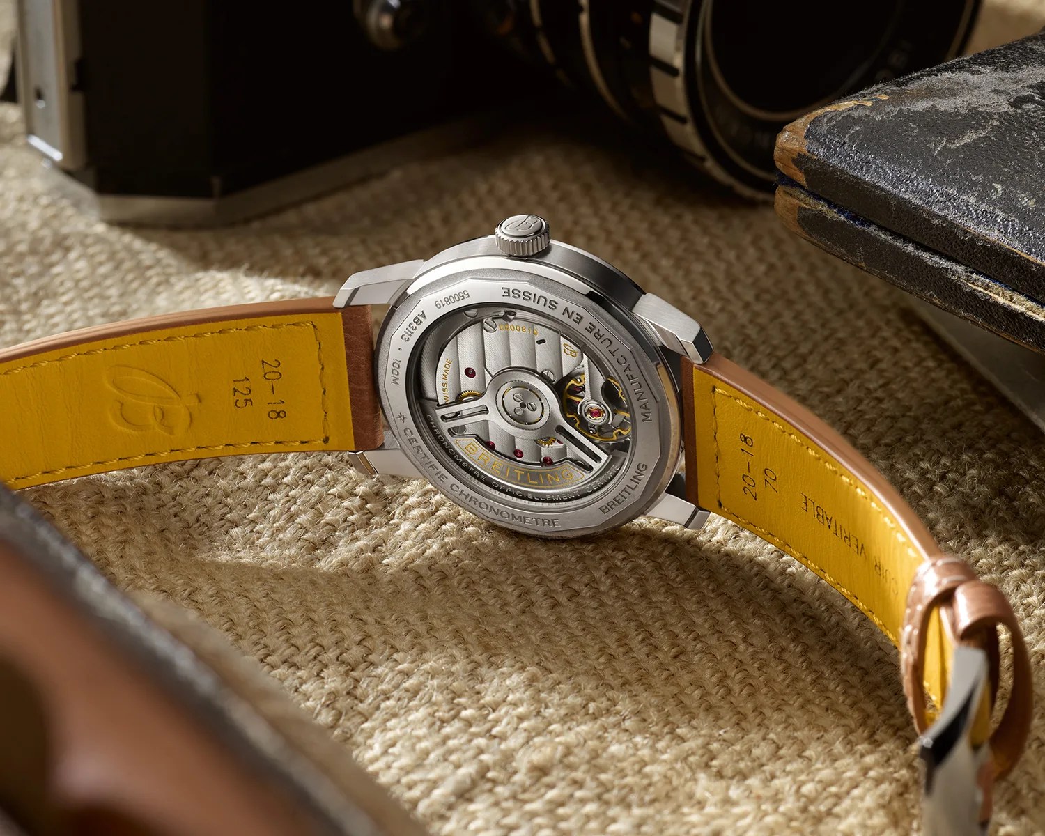 a breitling watch with a display caseback showing its automatic movement