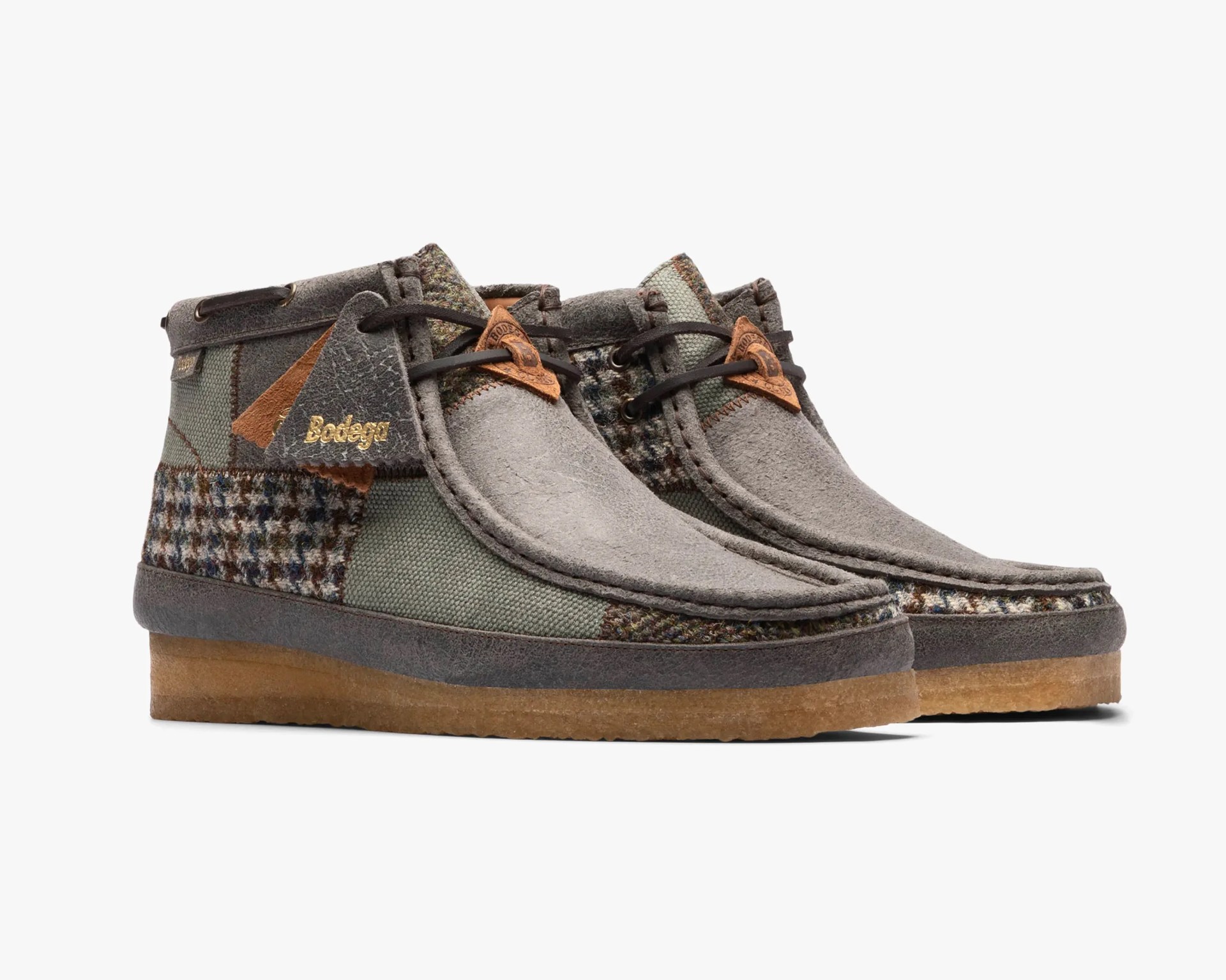 a pair of patchwork clarks wallabee boots