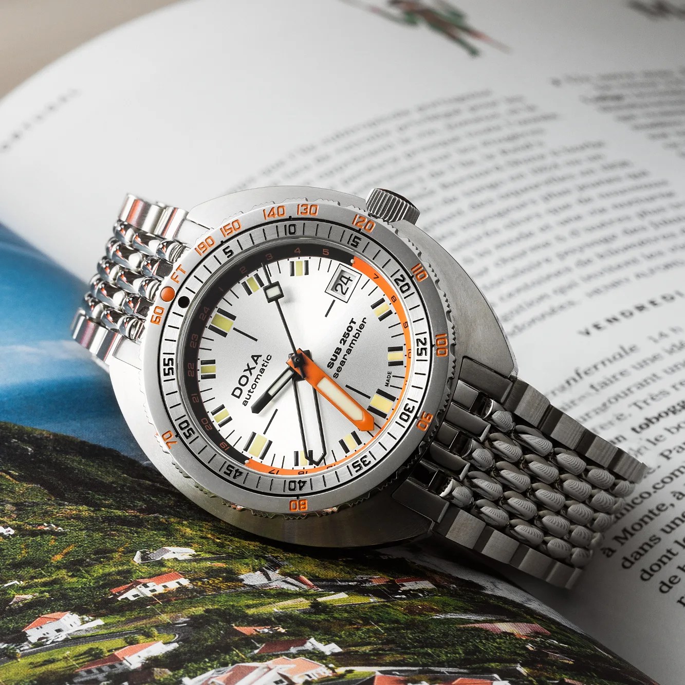 a silver dial Doxa GMT dive watch