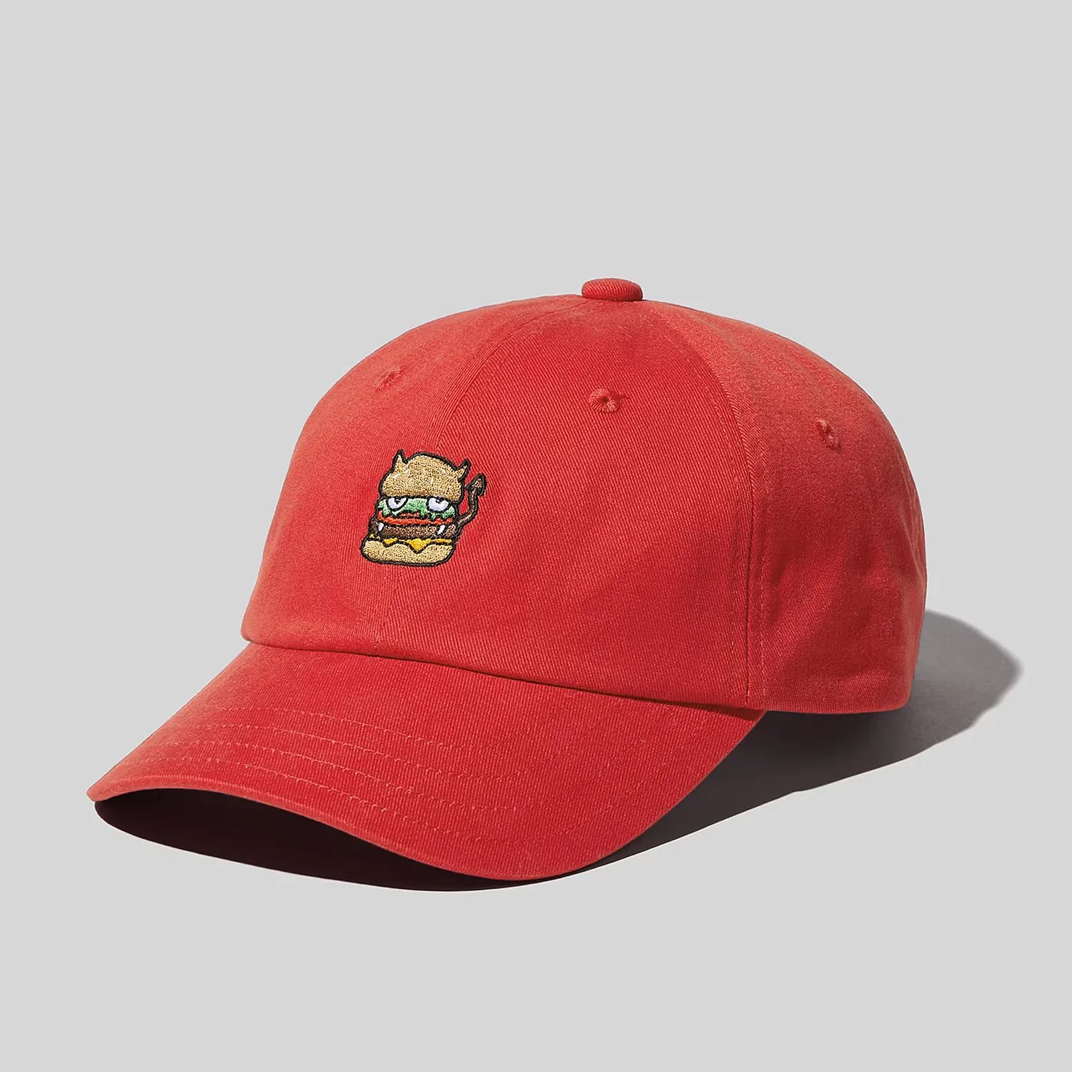 a red baseball hat with a cartoon burger on it