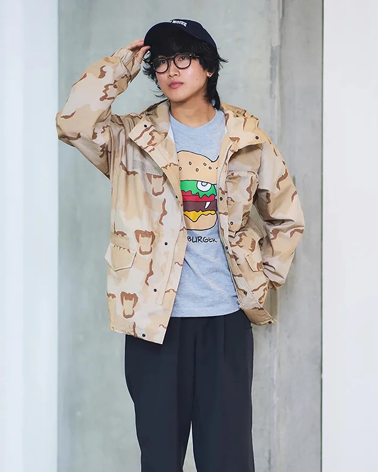 a man in a camo jacket, t-shirt and black hat