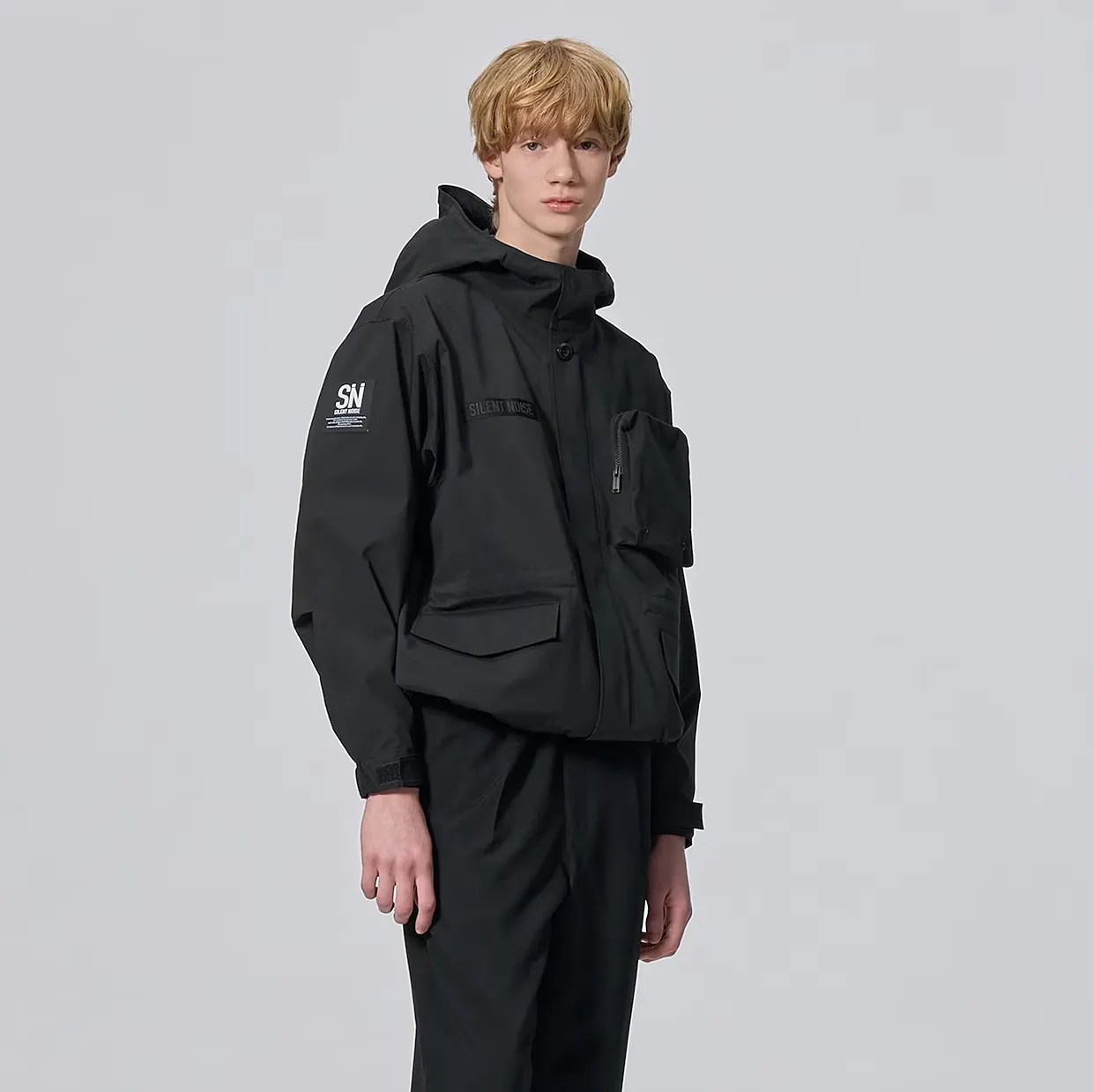 a man in a black rain jacket